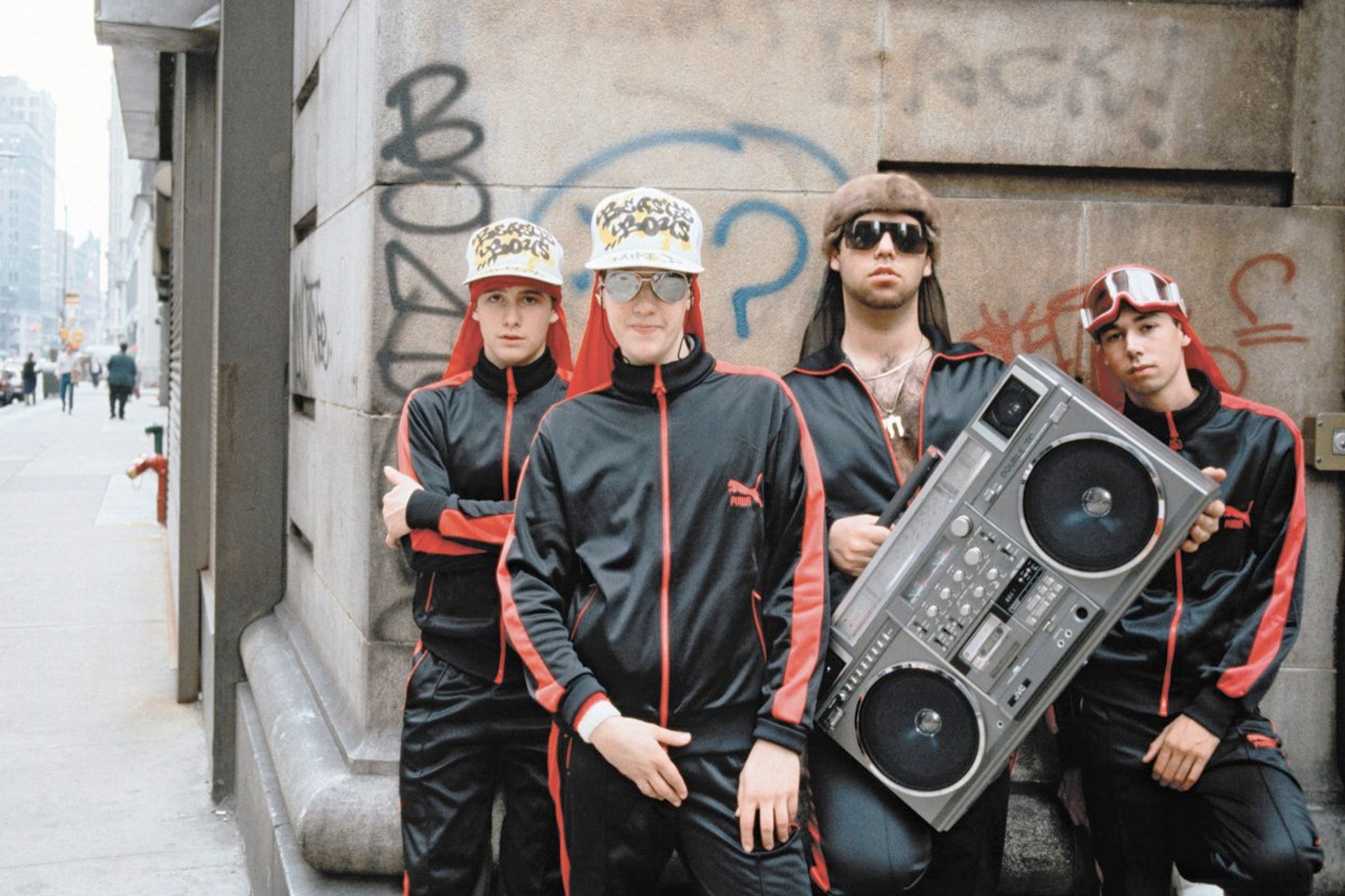 The Beastie Boys in Puma tracksuits with Rick Rubin (holding boombox)