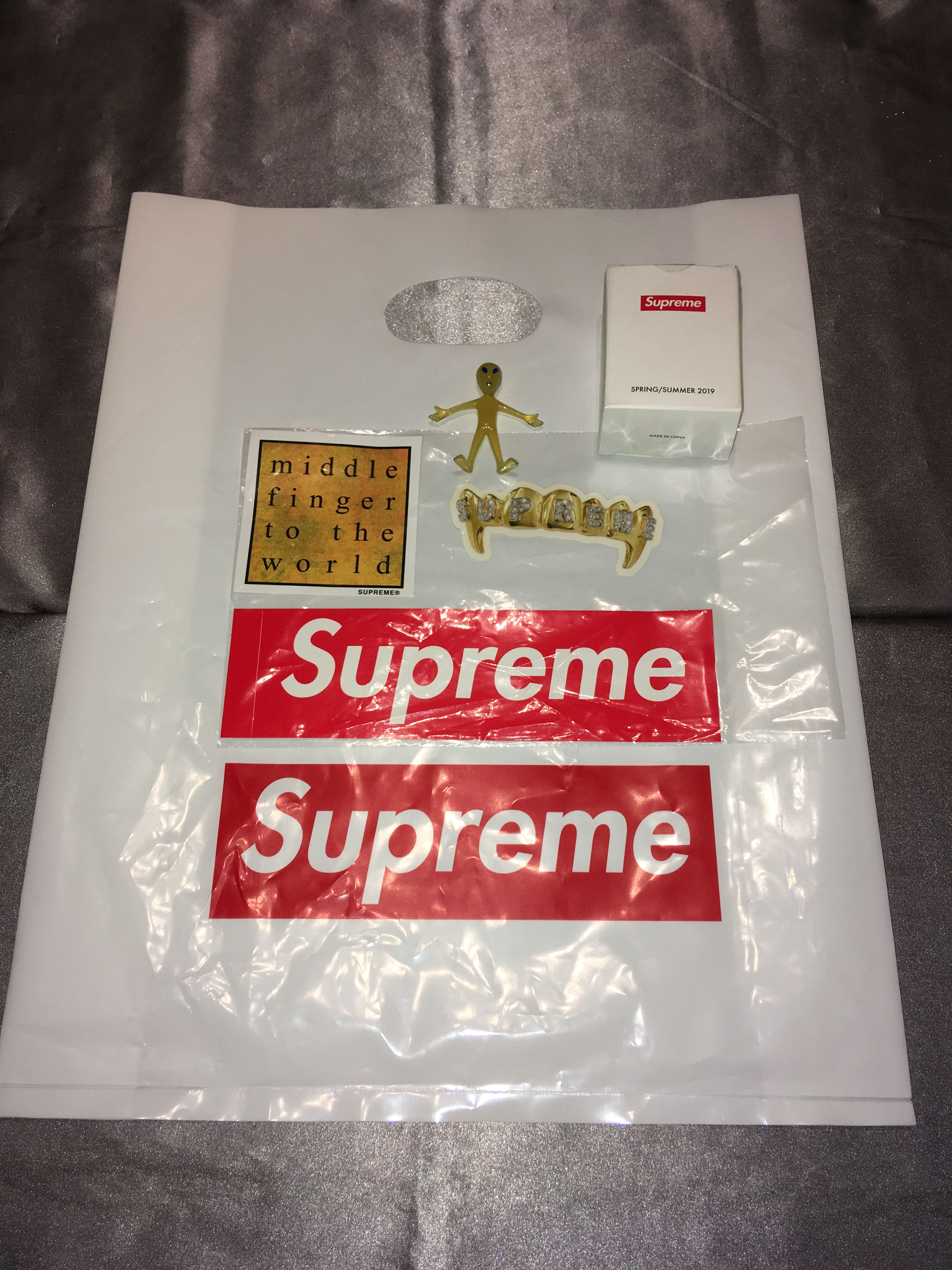 Supreme shirt, shower cap, shops stickers, and