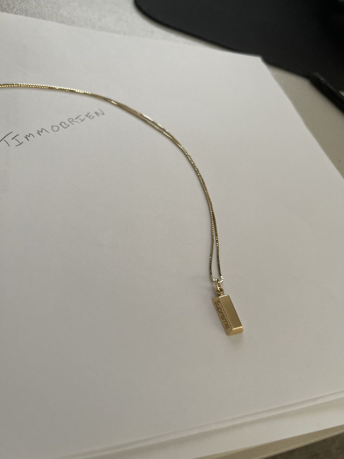 Supreme gold store bar pendant