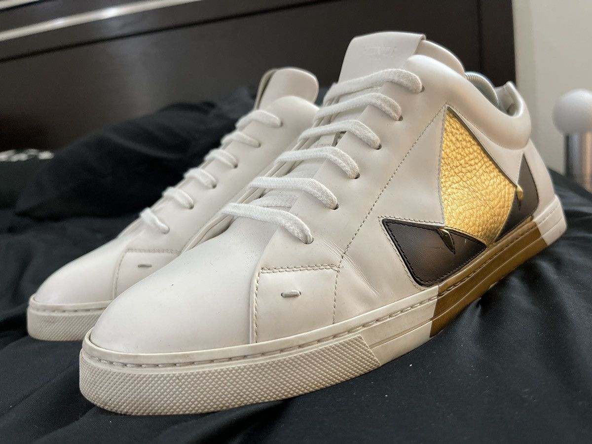 Fendi white leather low tops w gold bag bugs