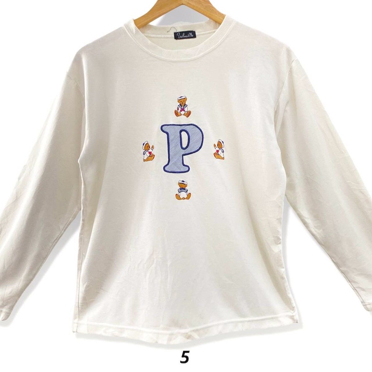 White sweatshirt with teddy bear