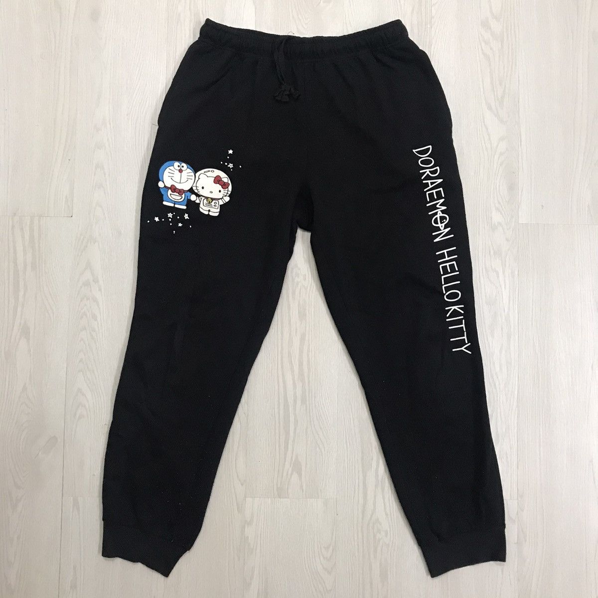 image of Anima x Cartoon Network Vintage Hello Kitty X Doraemon Anime Jogger Pants in Black, Men's (Size 29)