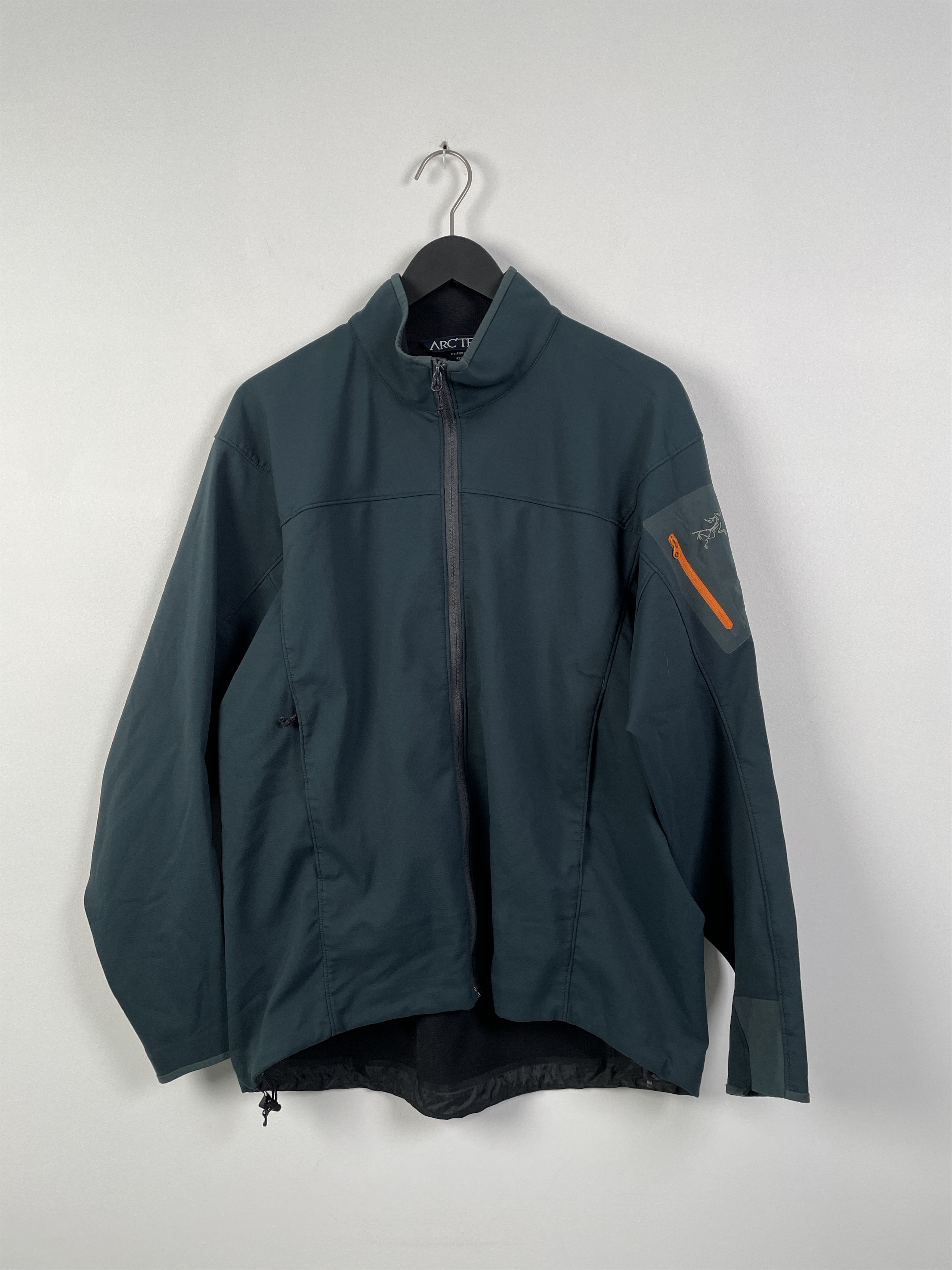 Arc'teryx Dark teal men's running jacket with orange contrast arm zip ...