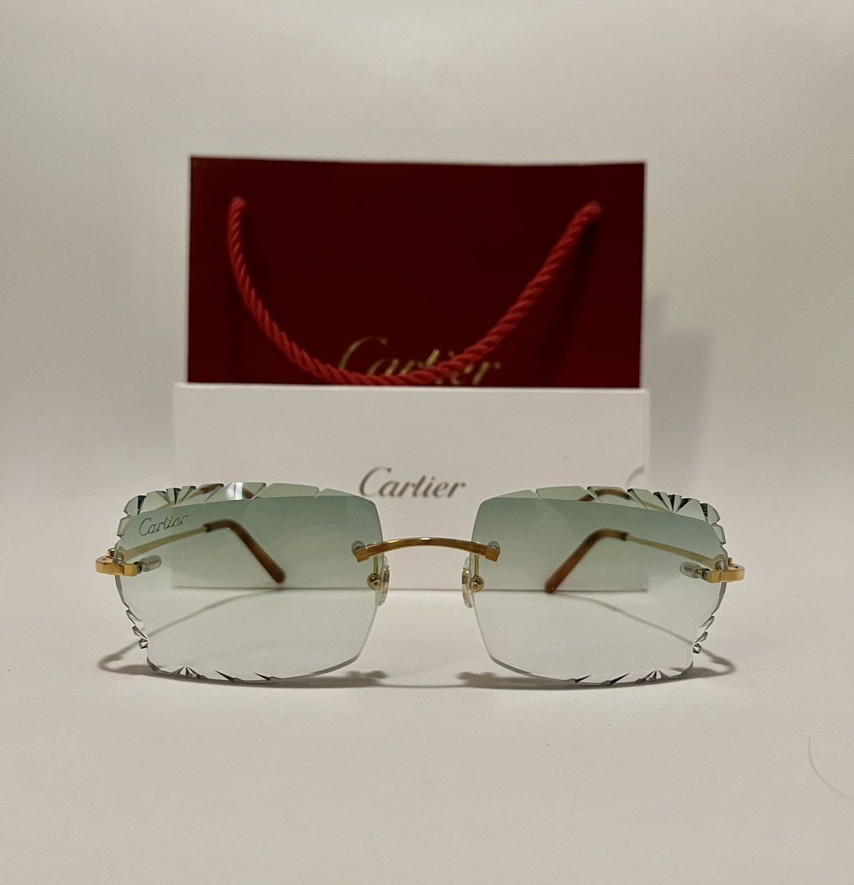 Cartier Cartier rimless Sunglasses c-decor diamond cut green CT0045O ...