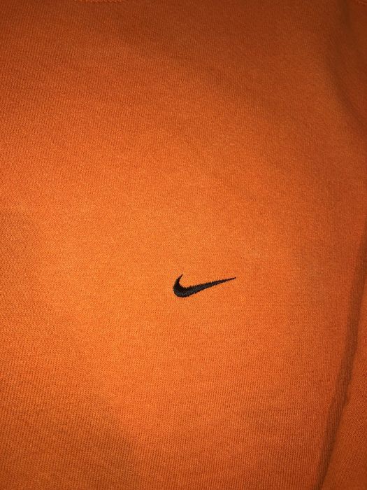 white nikes with orange swoosh