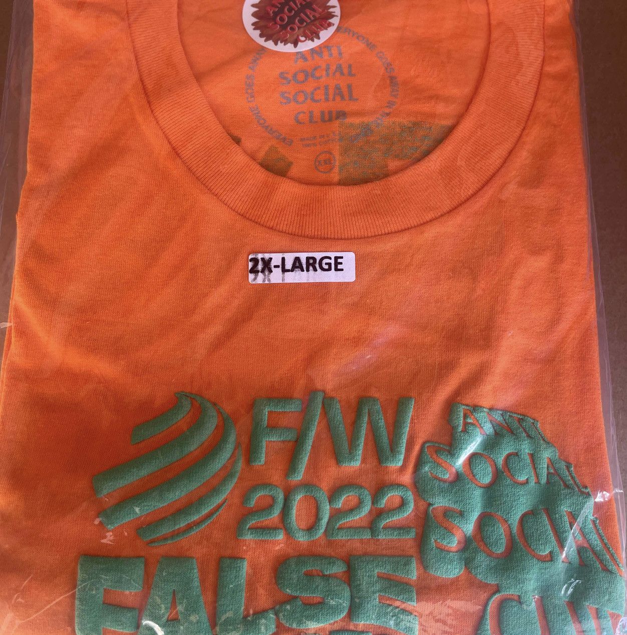 DS FW22 Green ASSC False Promises Orange Tee BApe Kith kaws
