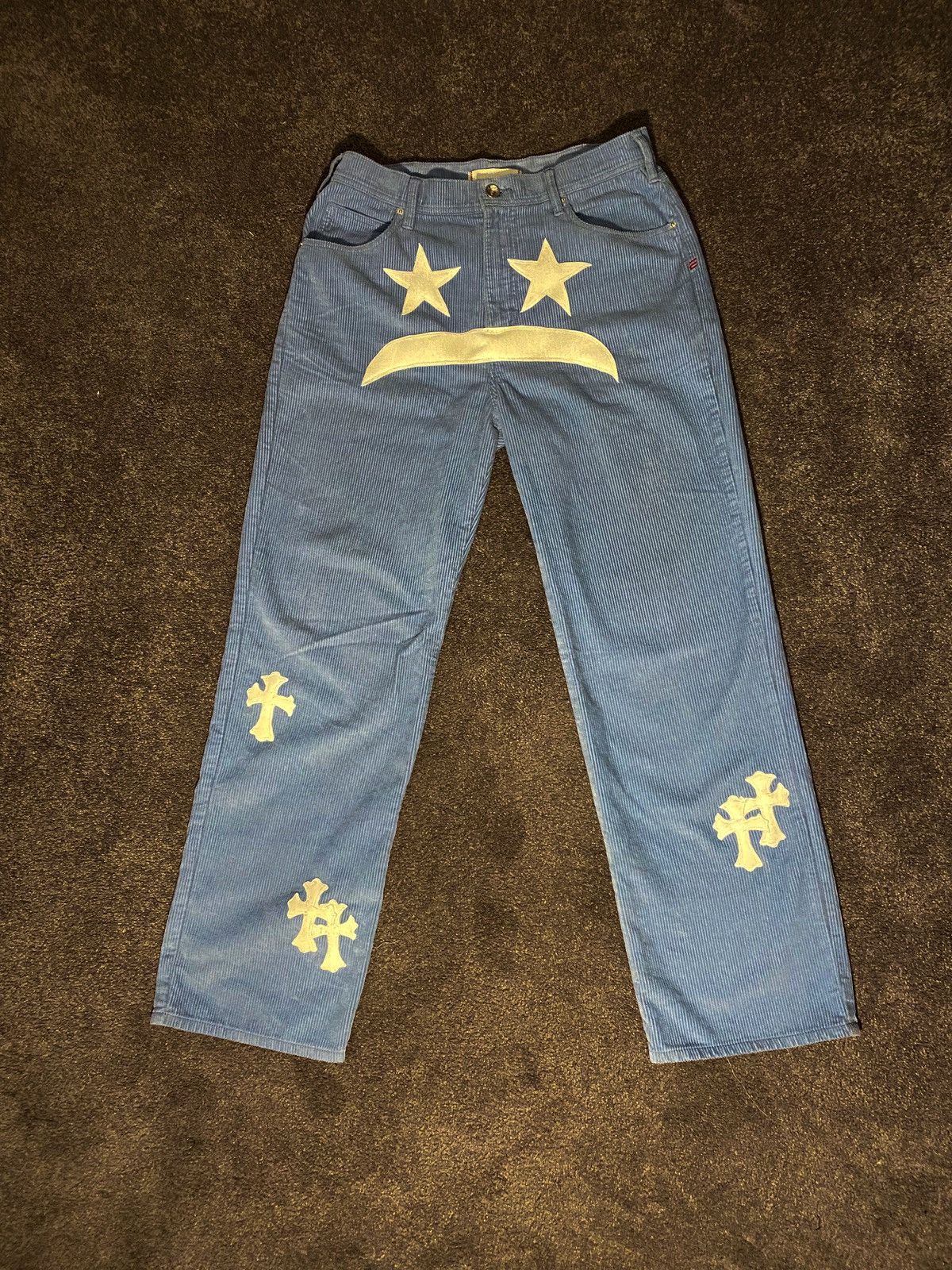 1 of 1 sewn “sad face with cross” on corduroy pants
