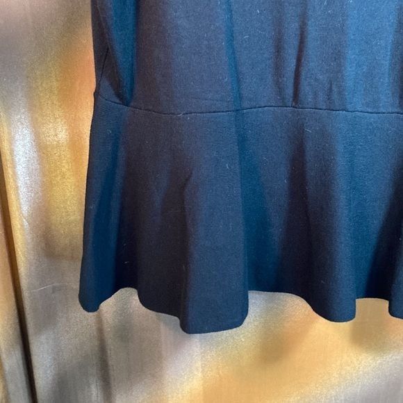 Black Thalia Sodi sweater with keyhole neck and peplum waist