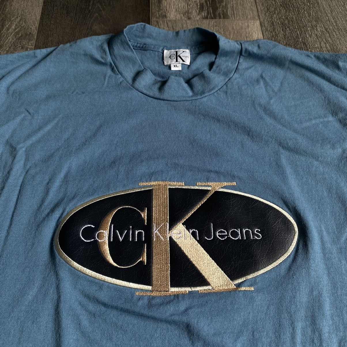 Calvin Klein Vintage 1990s Calvin Klein Jeans Patch Embroidered Logo Tee Size US XL / EU 56 / 4 - 1 Thumbnail