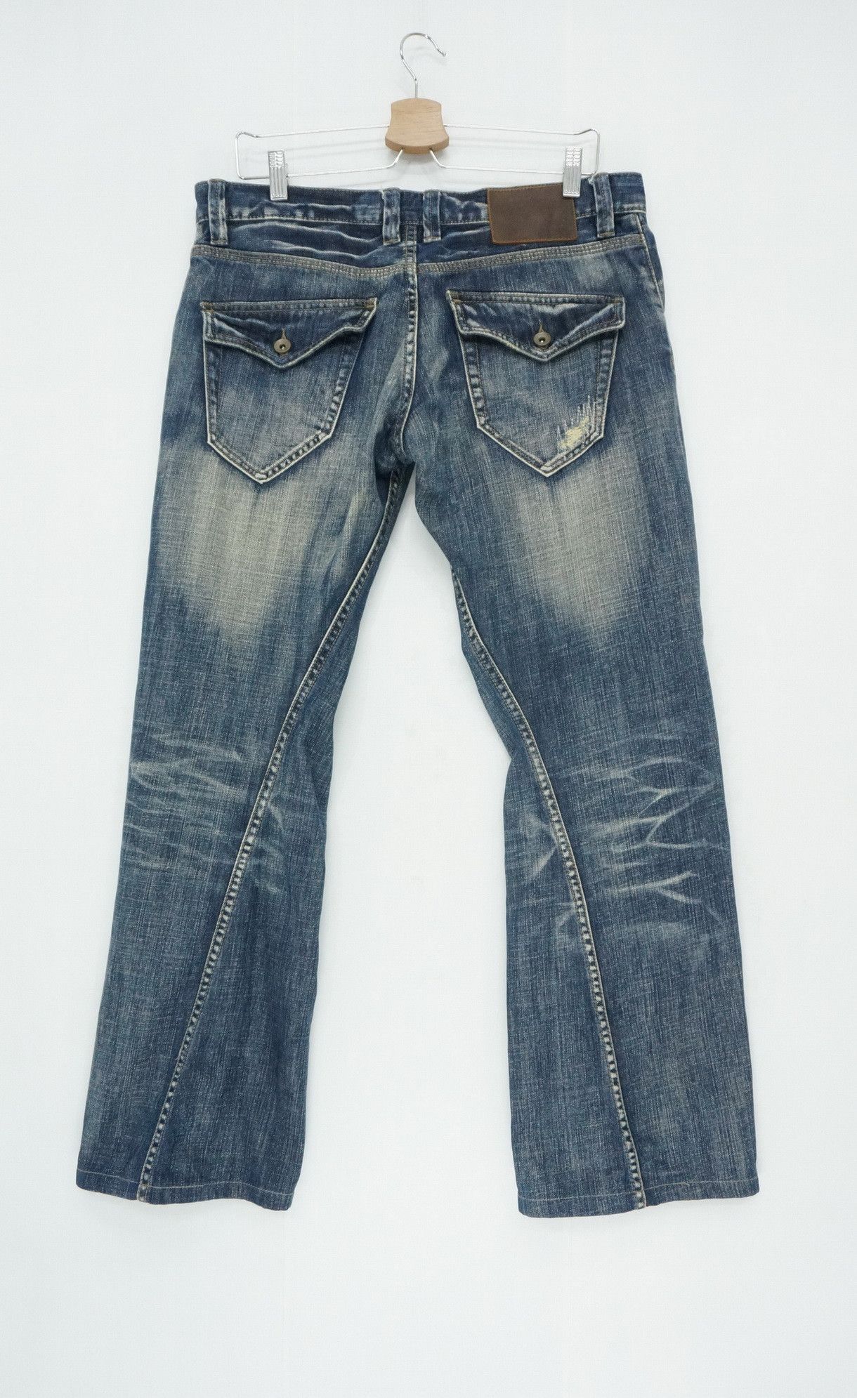 image of Issey Miyake x Tete Homme Twisted Seam Flared Lowrise Jeans in Dark Blue Denim, Men's (Size 33)