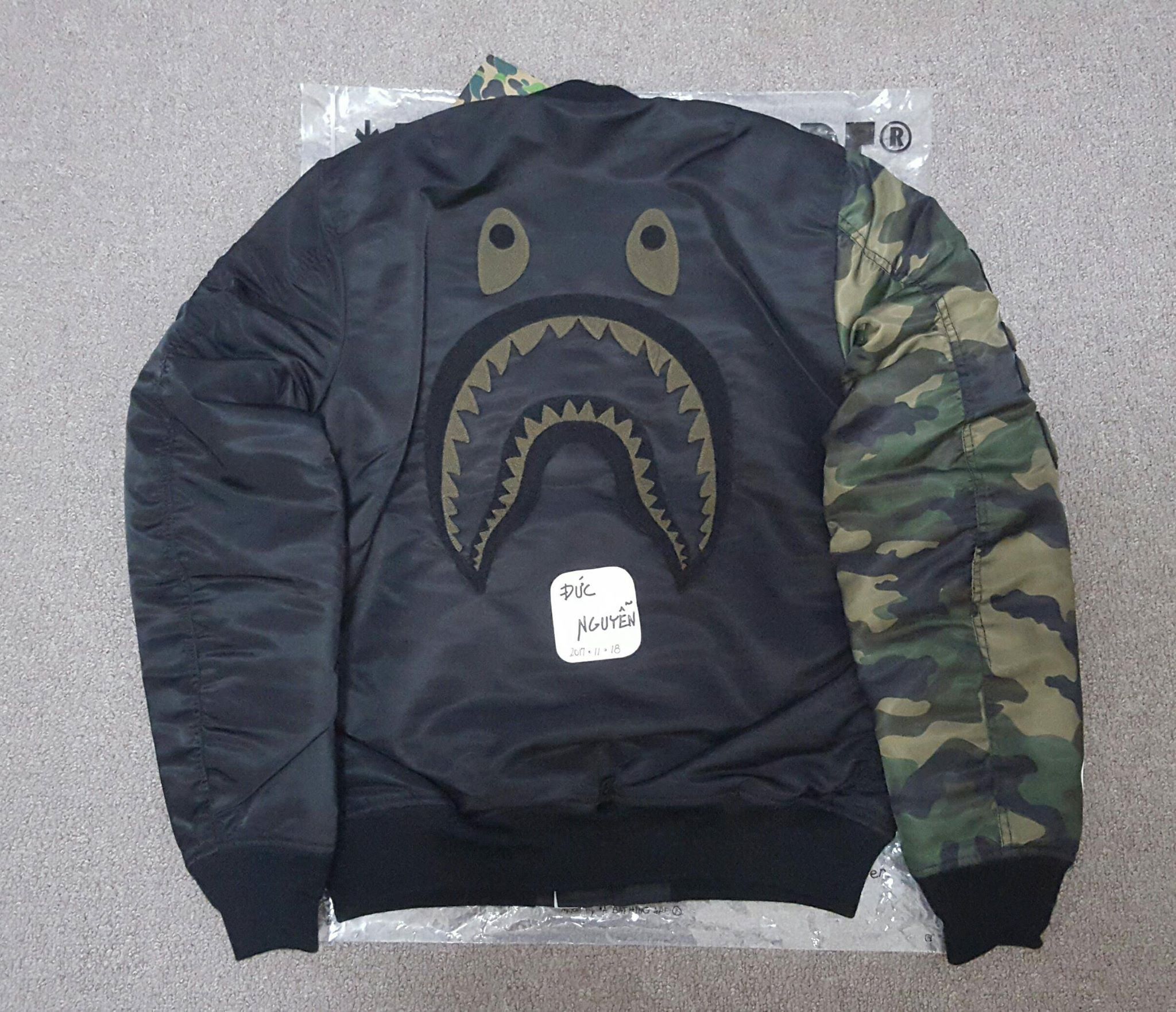 BAPE® X UNDEFEATED CAMO SHARK MA-1 BAPE × undefeated shark MA-1 bomber jacket Black A Bathing