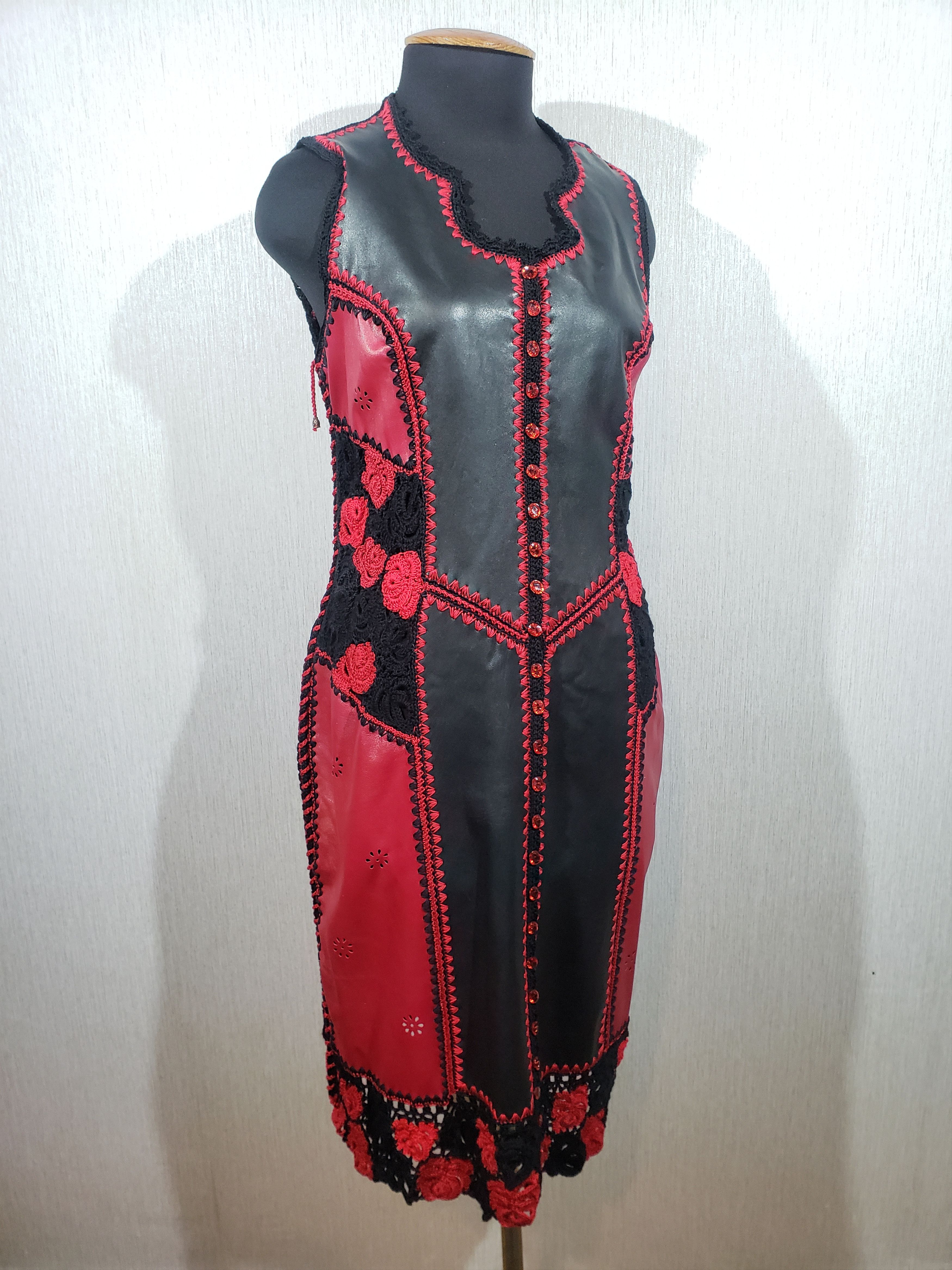 Delicate dress made of black leather with fragments.