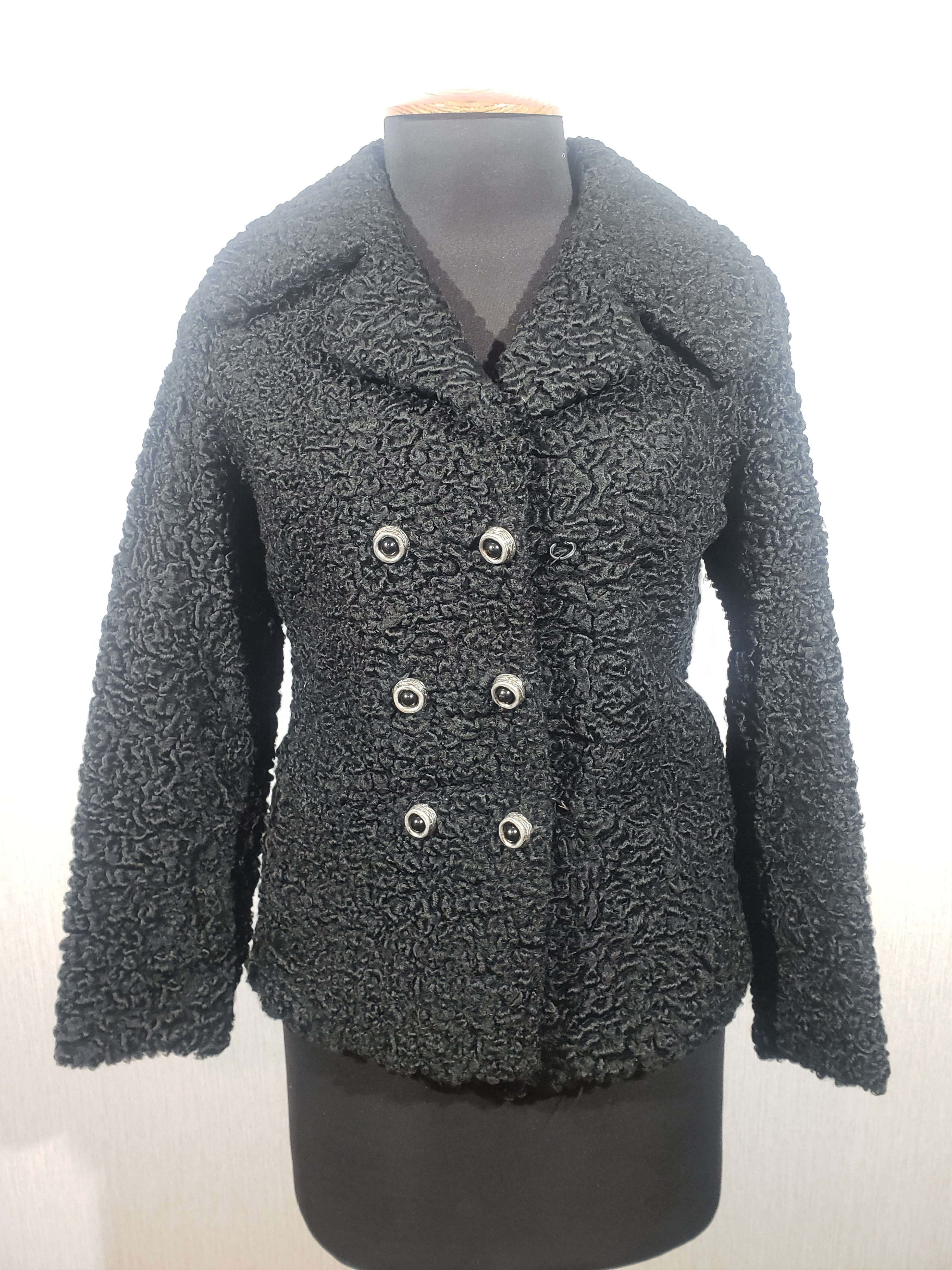 Warm reliable coat made of black sheep fur.