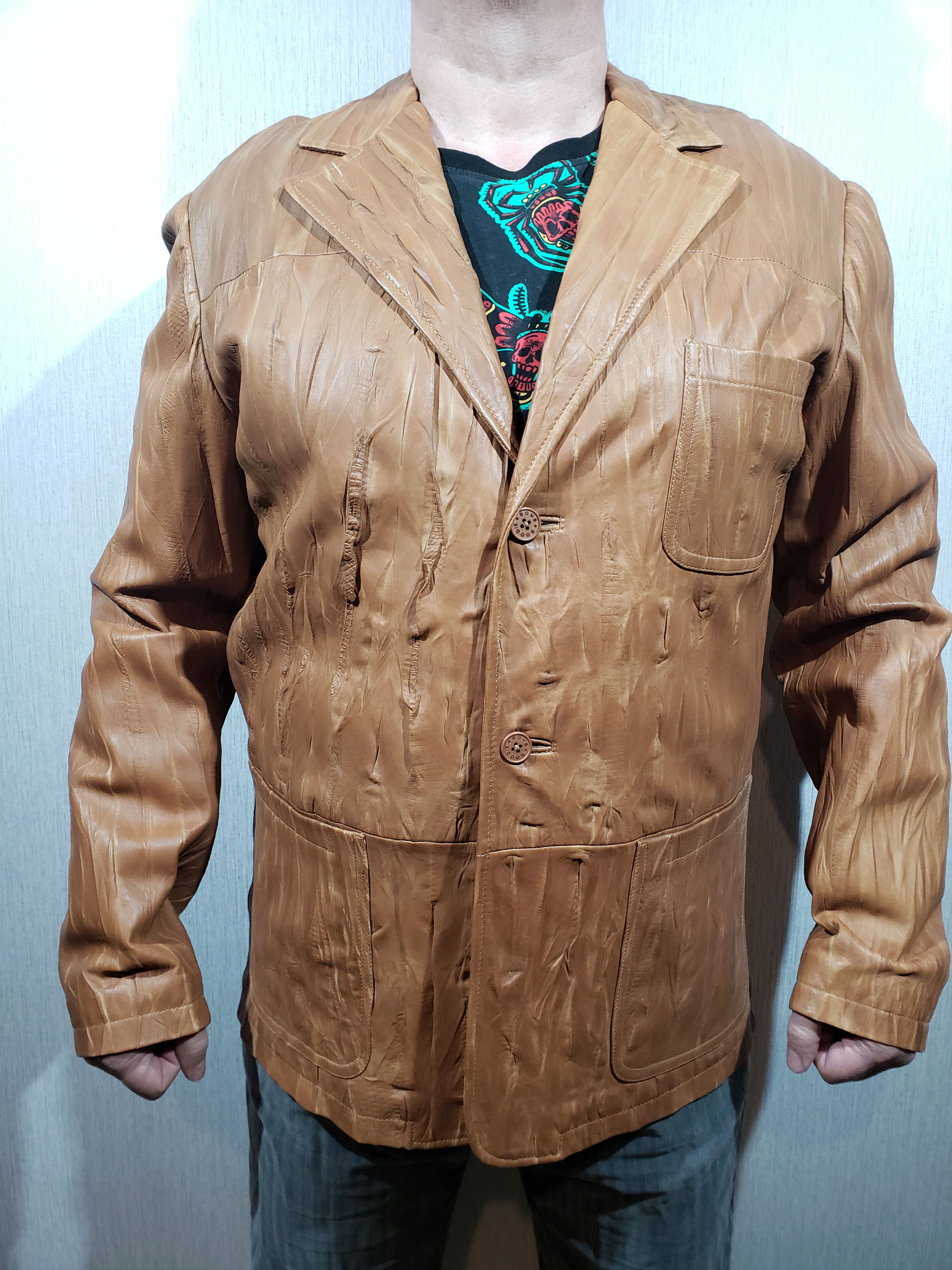 Stylish men's leather jacket with buttons.