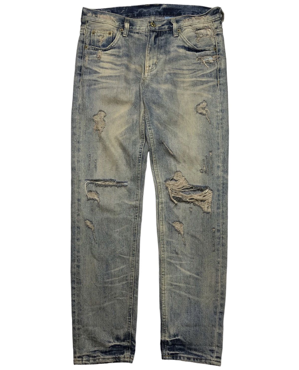 Distressed dirty denim jeans