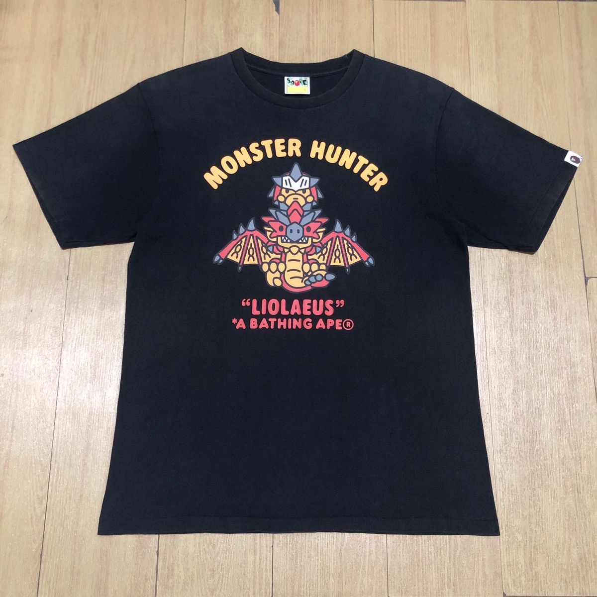 image of Bape X Capcom Monster Hunter Baby Milo T-Shirts in Black, Men's (Size Medium)