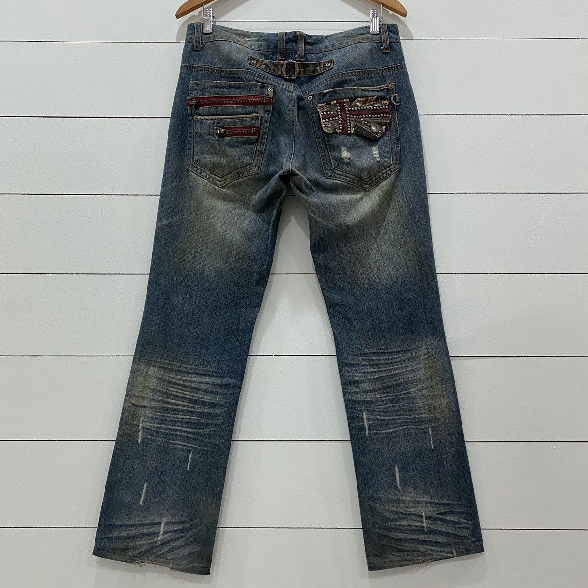 Semantic Design Buckle Distressed Denim Jeans