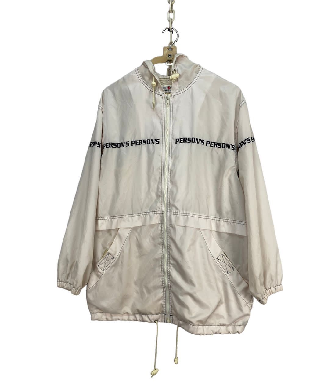 Person’s spellout hoodie zipper jacket