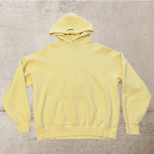 Fear of god essentials online lemonade pullover hoodie yellow