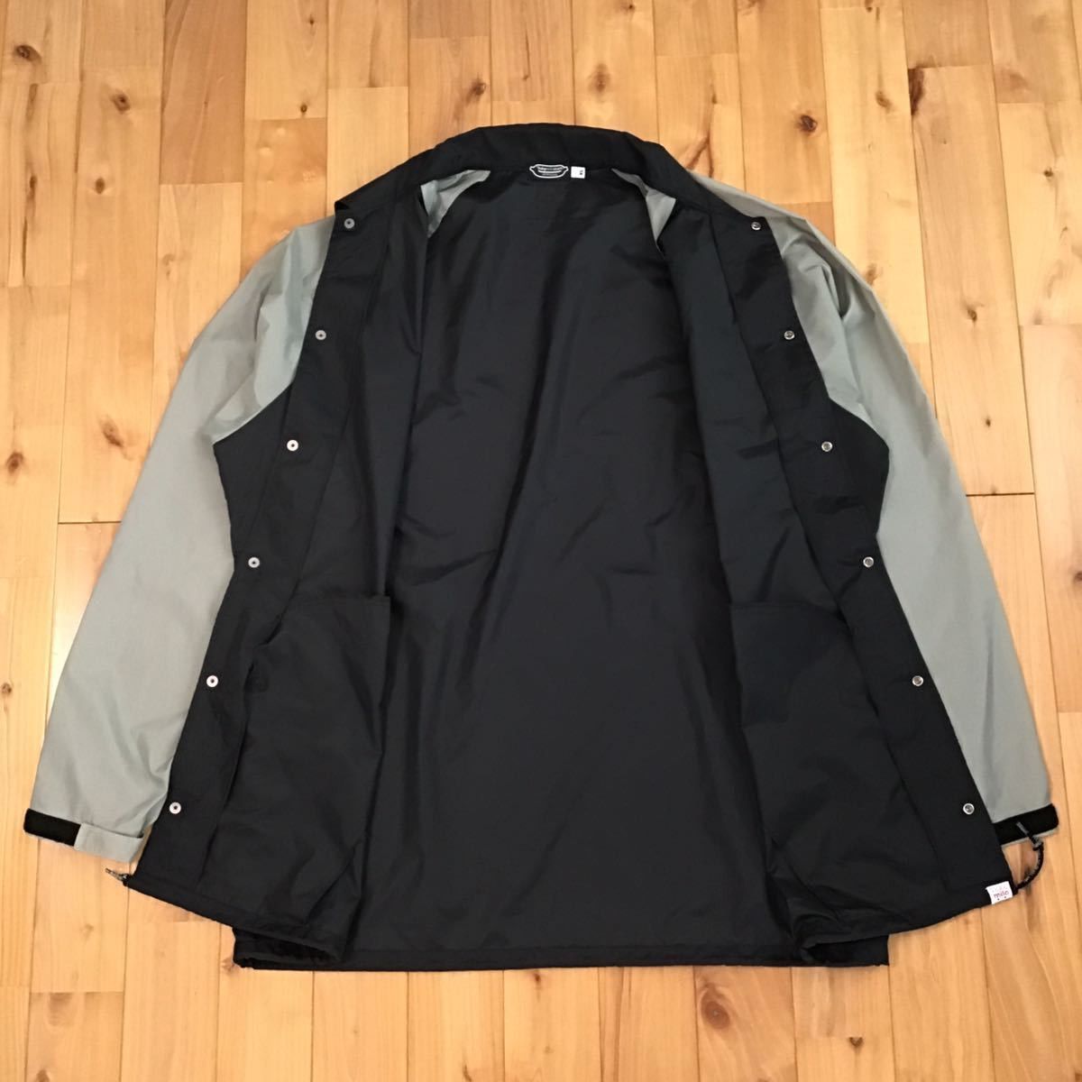 Bape × Kaws BAPE × KAWS milo nylon coach jacket black × gray Size US XL / EU 56 / 4 - 5 Thumbnail