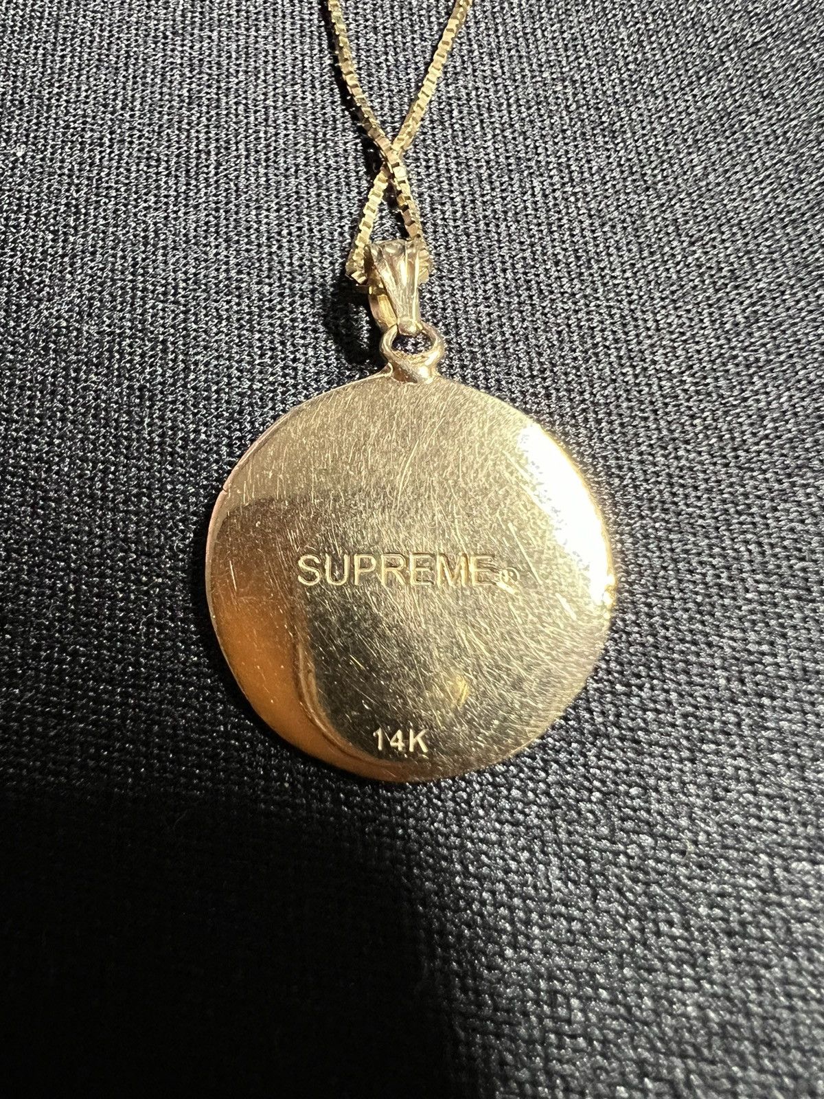 Supreme justice clearance gold pendant