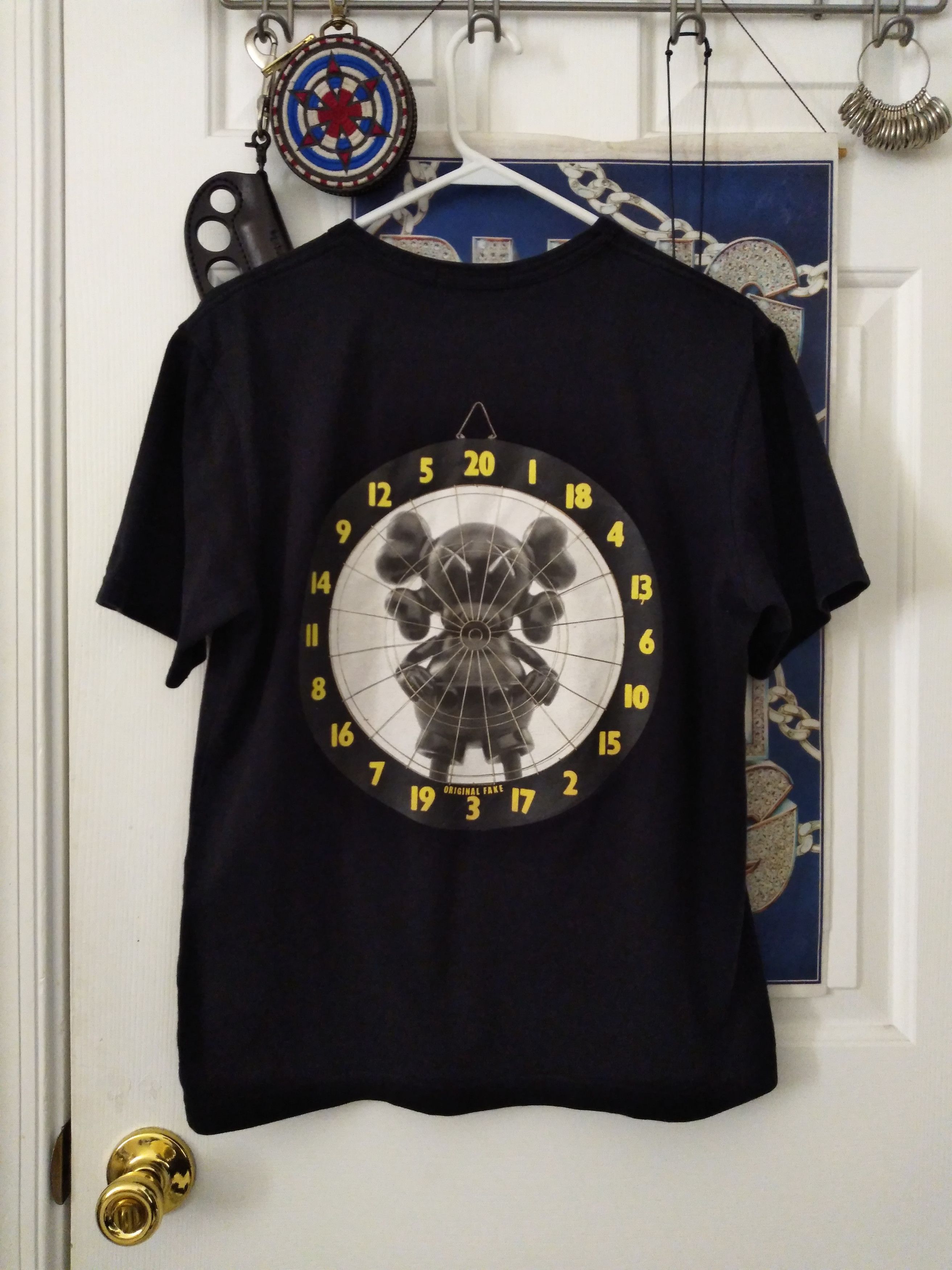 image of Originalfake Kaws Dartboard Pocket T-Shirt in Black, Men's (Size Medium)