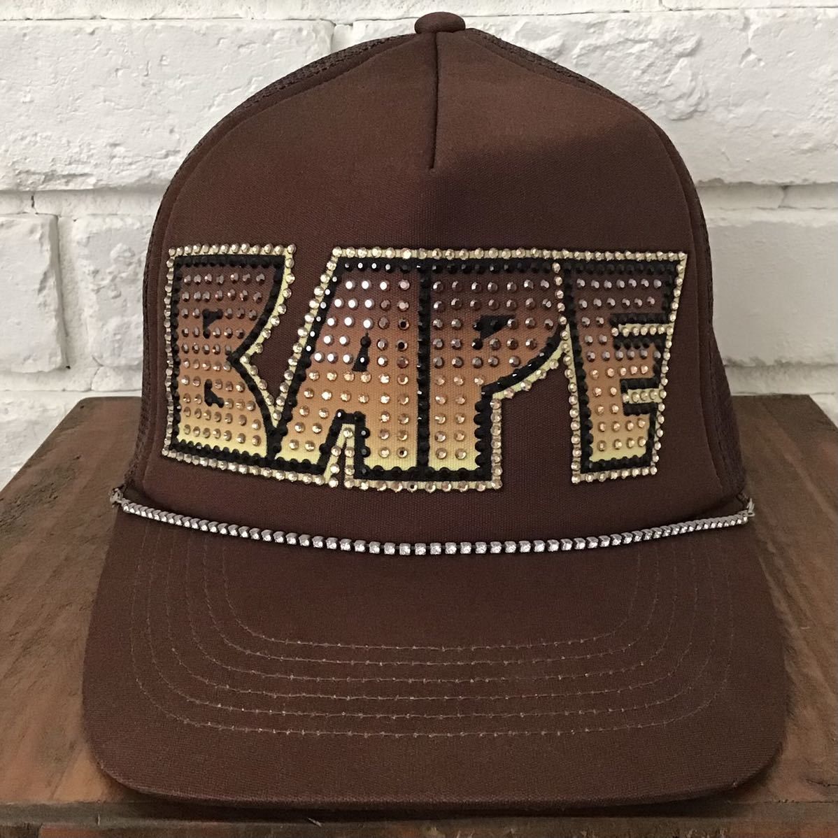image of Bape Kiss Logo Swarovski Trucker Hat Cap in Brown, Men's