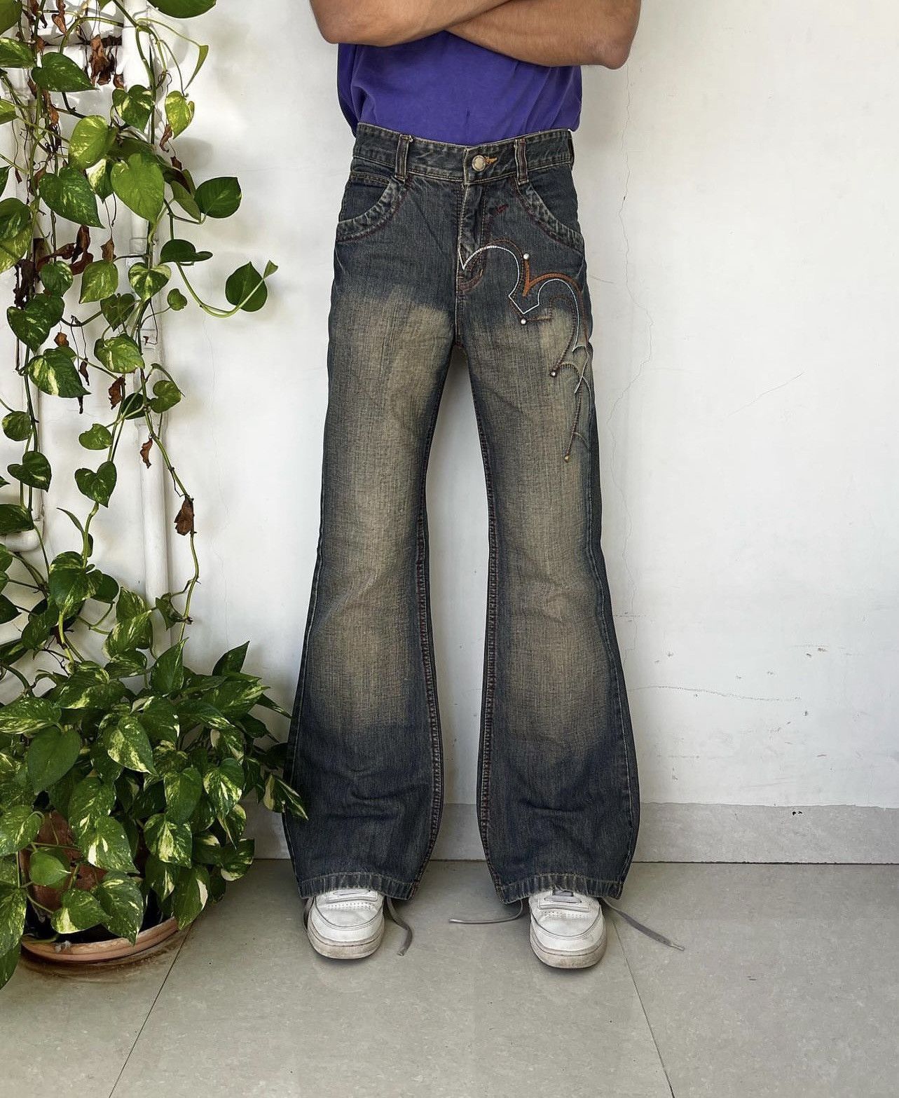Y2K mudwash embroidered wide-leg flared jeans.
