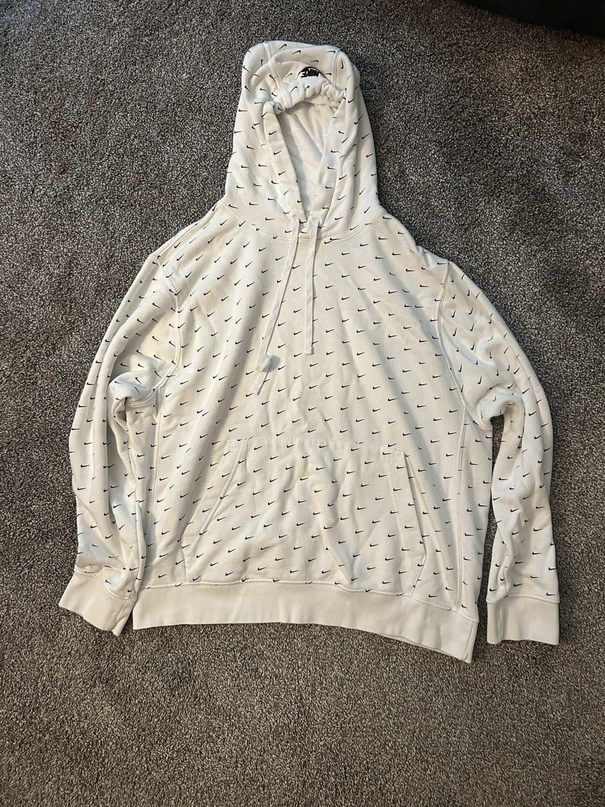 white nike hoodie with nike all over it
