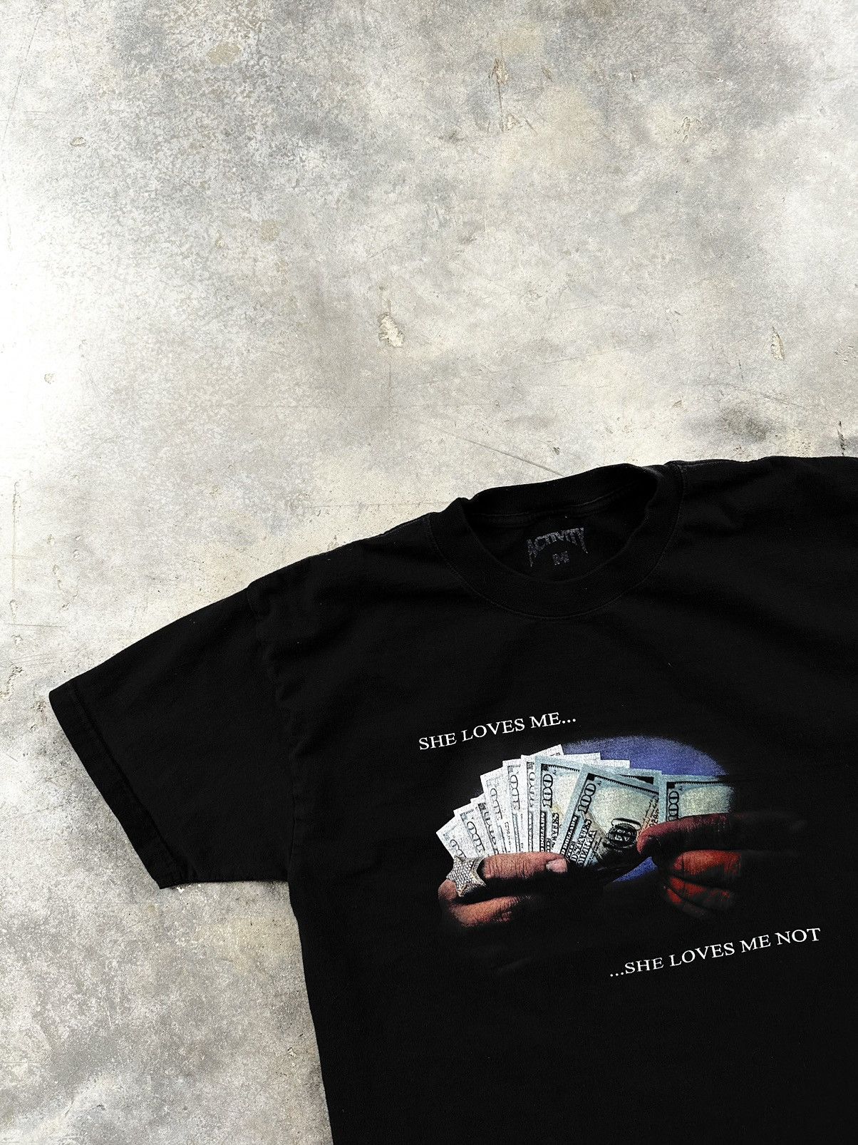 image of Activity " She Loves Me, She Loves Me Not " Black Money Tee, Men's (Size Medium)