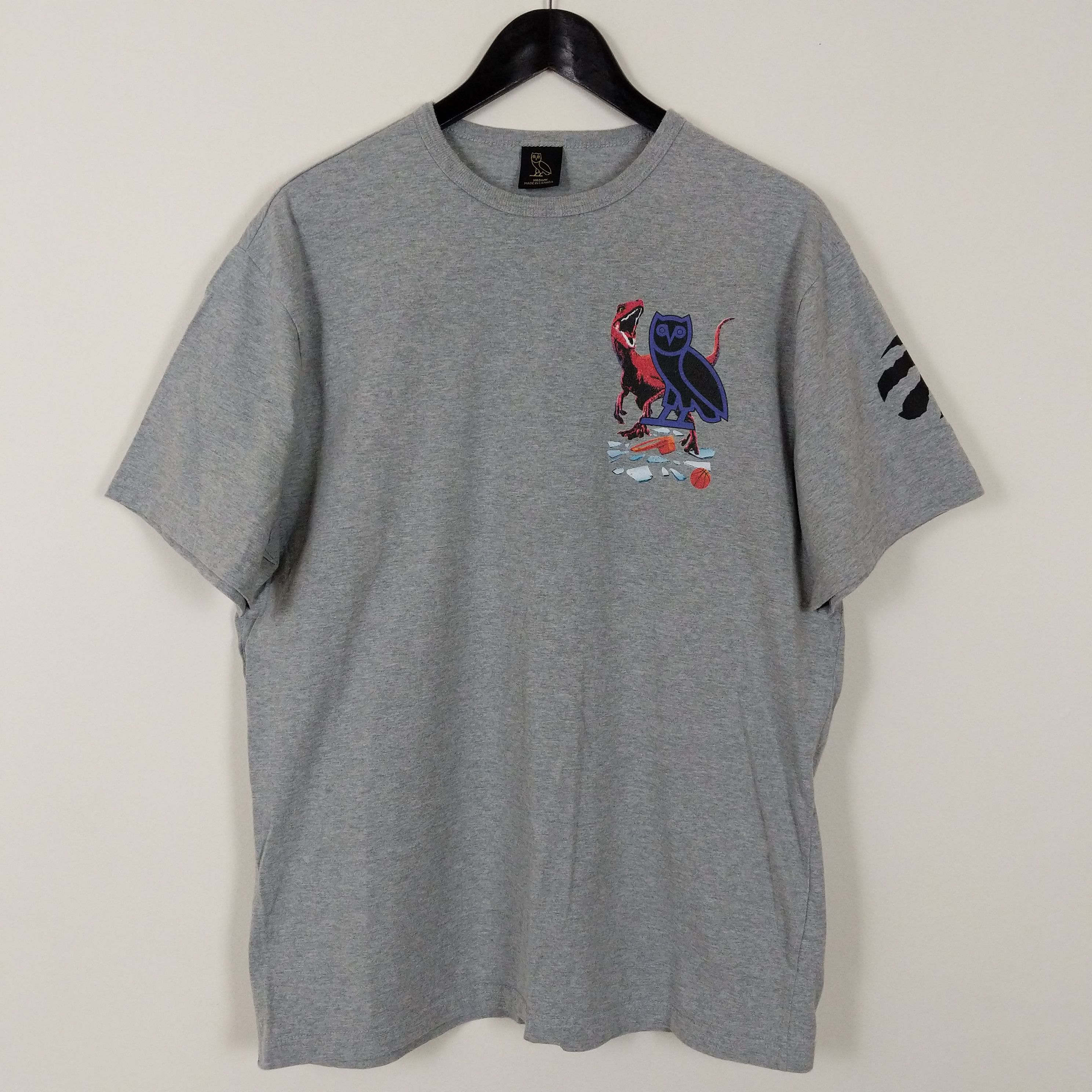 NBA × October's Very Own OVO Jurassic Park Toronto Raptors Shattered Backboard Tee Size US M / EU 48-50 / 2 - 1 Thumbnail