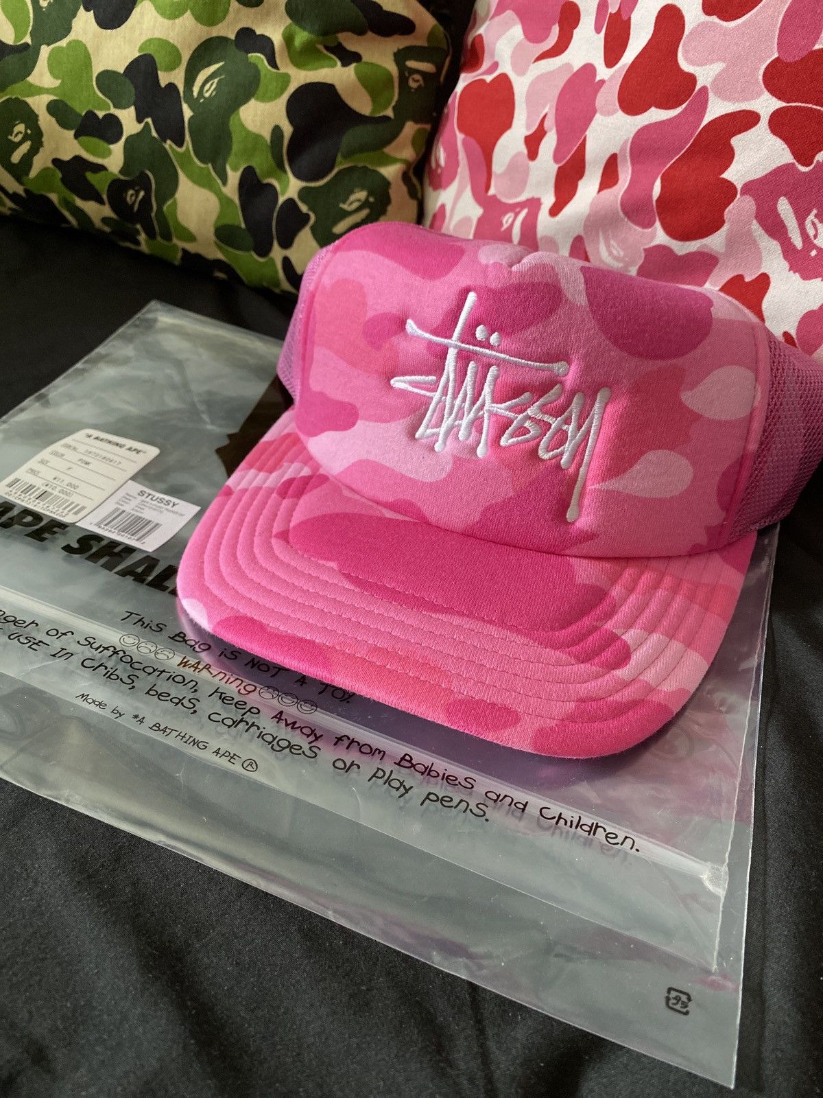 image of Bape x Stussy Trucker Hat in Pink, Men's