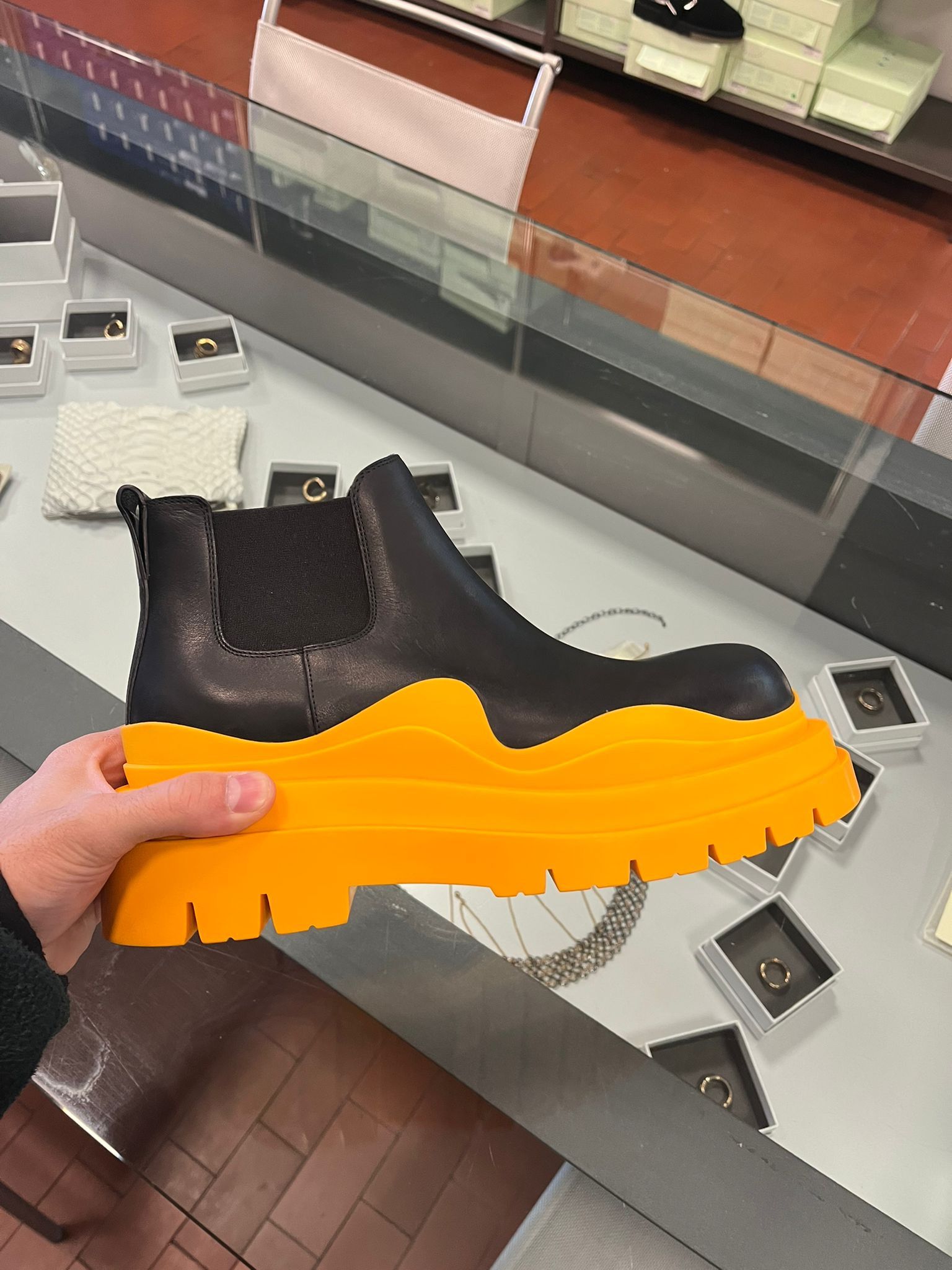 image of Bottega Veneta O1D11Kos Low Top Tire Lug Boots In Black / Orange in Black/Orange, Men's (Size 12)
