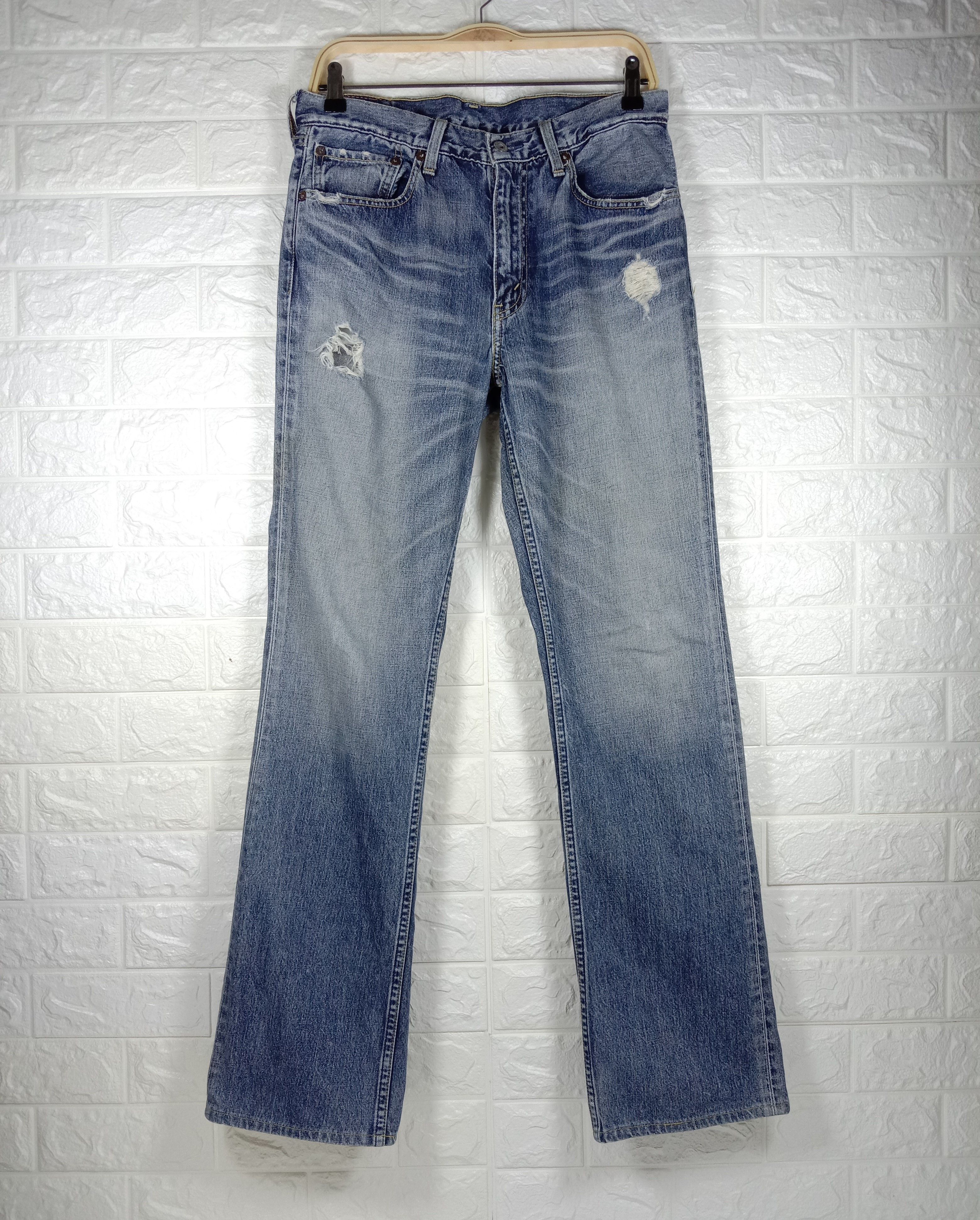 image of Vintage Levi’S 507 Jeans Earth Tone Distressed Denim in Blue, Men's (Size 32)