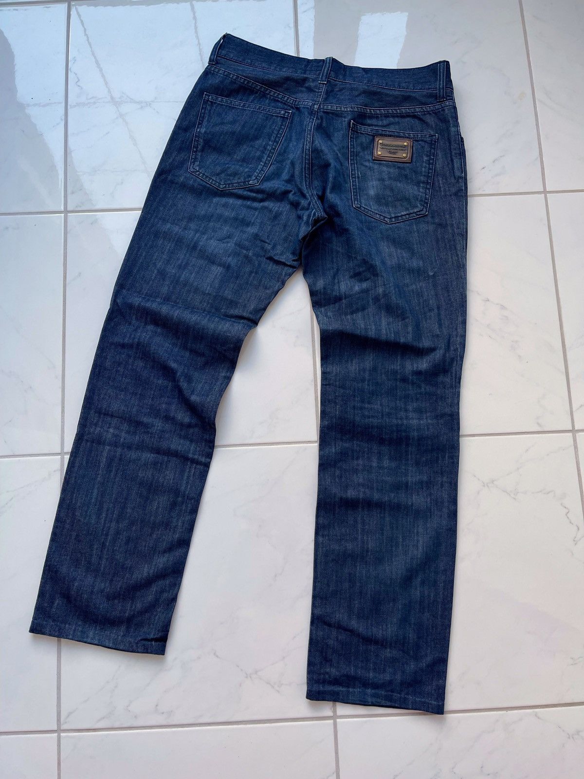 image of Dolce Gabbana Metallic Tab Logo Distressed Jeans in Denim, Men's (Size 34)