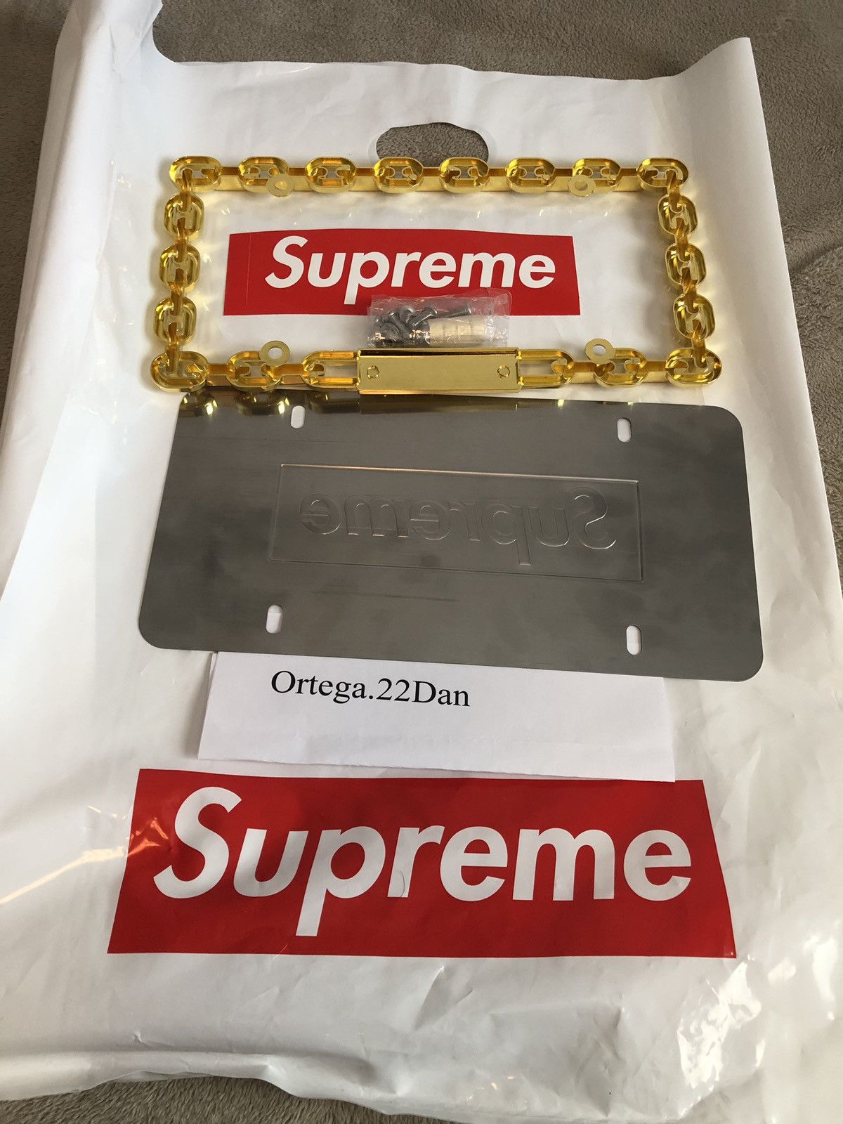 Supreme chain outlet license plate frame