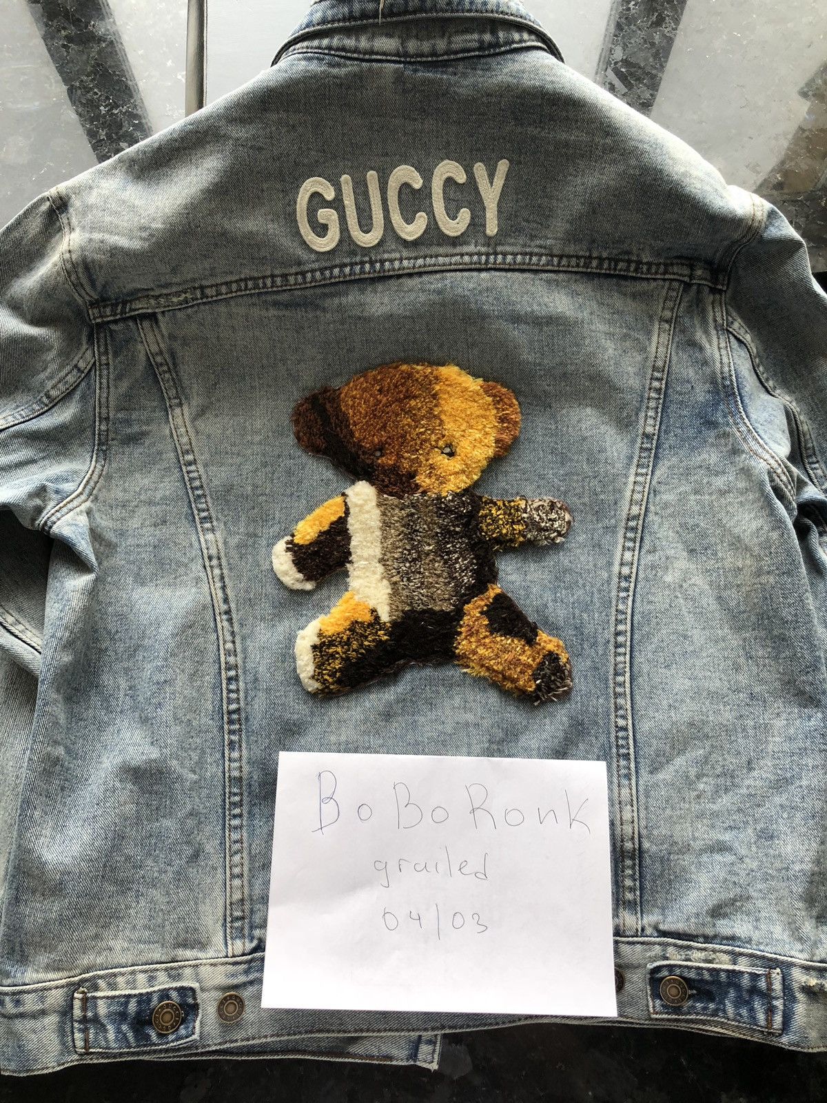 Gucci denim jacket shop with teddy bear