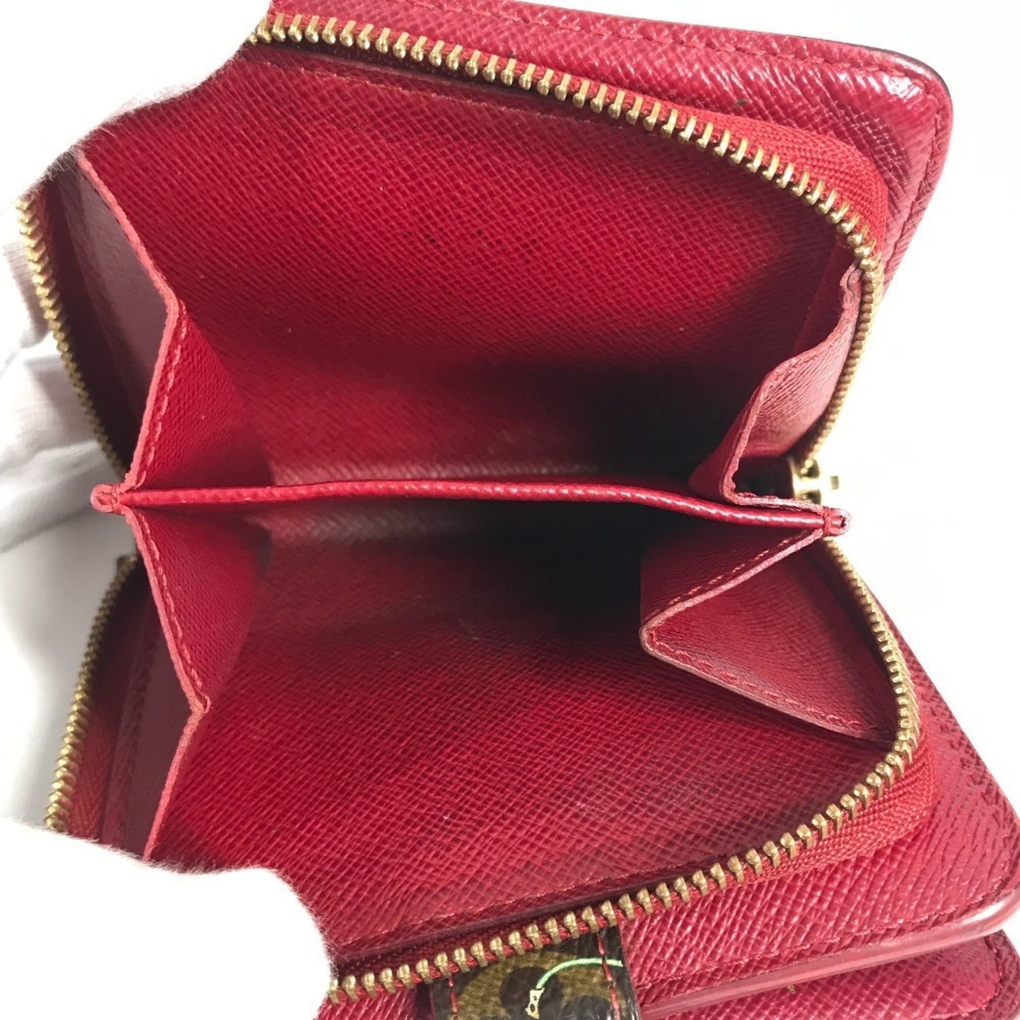 LOUIS VUITTON M95005 Monogram Cherry Compact Zip Wallet, designed by Takashi Murakami, featuring a cherry design. This compact, bi-fold wallet is crafted from canvas and available in brown for both men women.