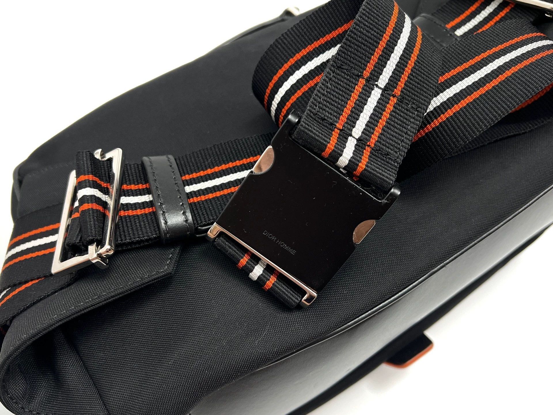 Black Crossbody Bag with Striped Strap and Buckle