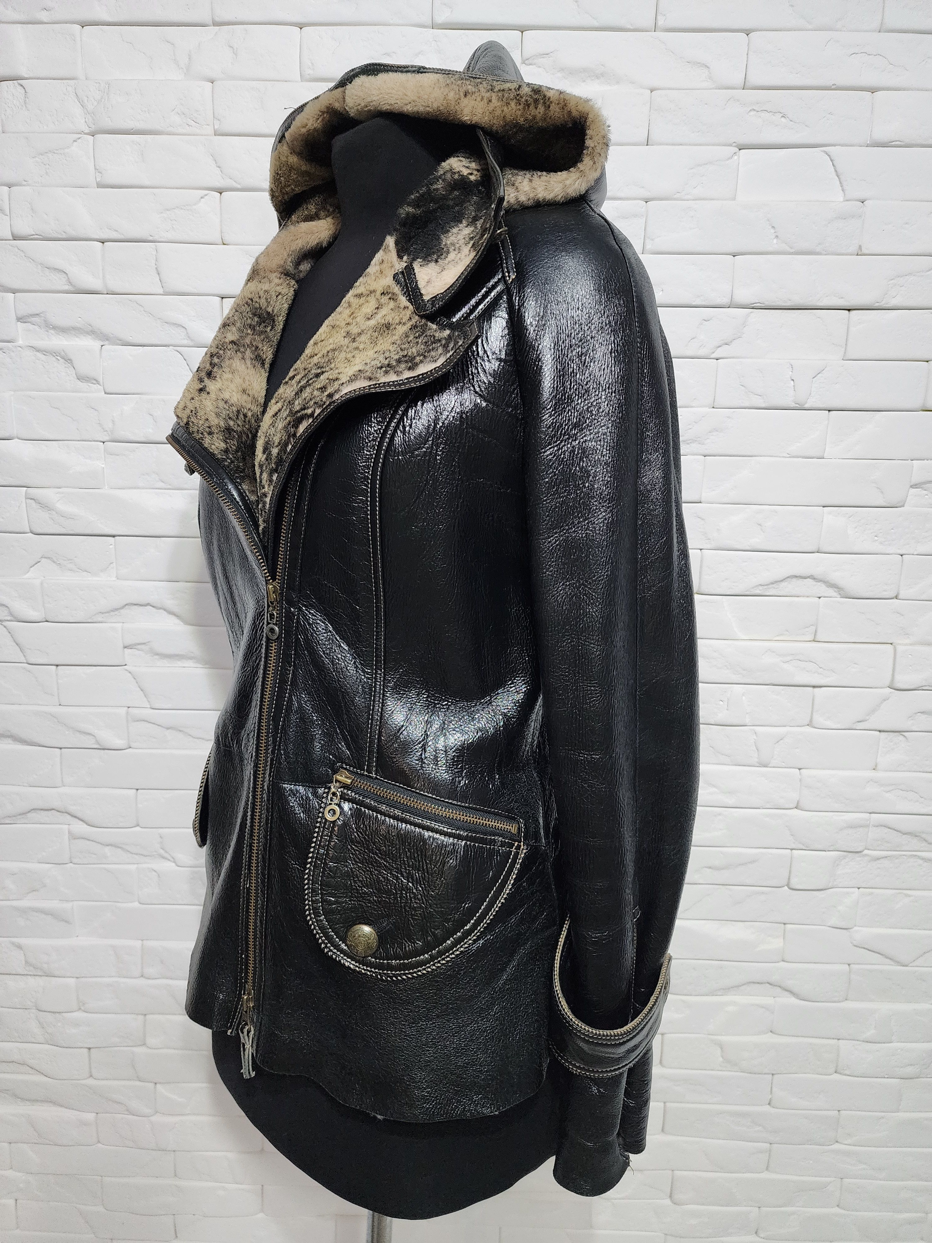Black sheepskin coat with a metal zipper and hood.
