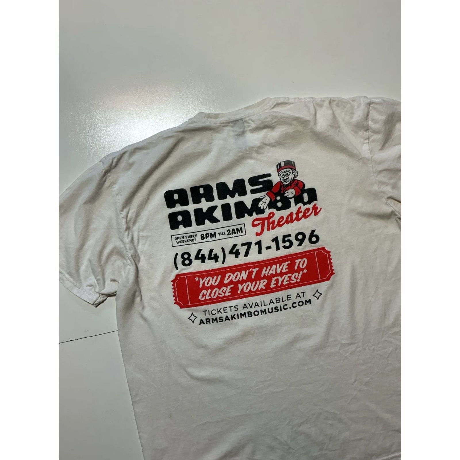 Gildan Arms Akimbo Theater Music Alternative Indie Rock Band White S/S T-Shirt XL Mens Gildan Shirt Graphic T-Shirt Size US XL / EU 56 / 4 - 5 Thumbnail
