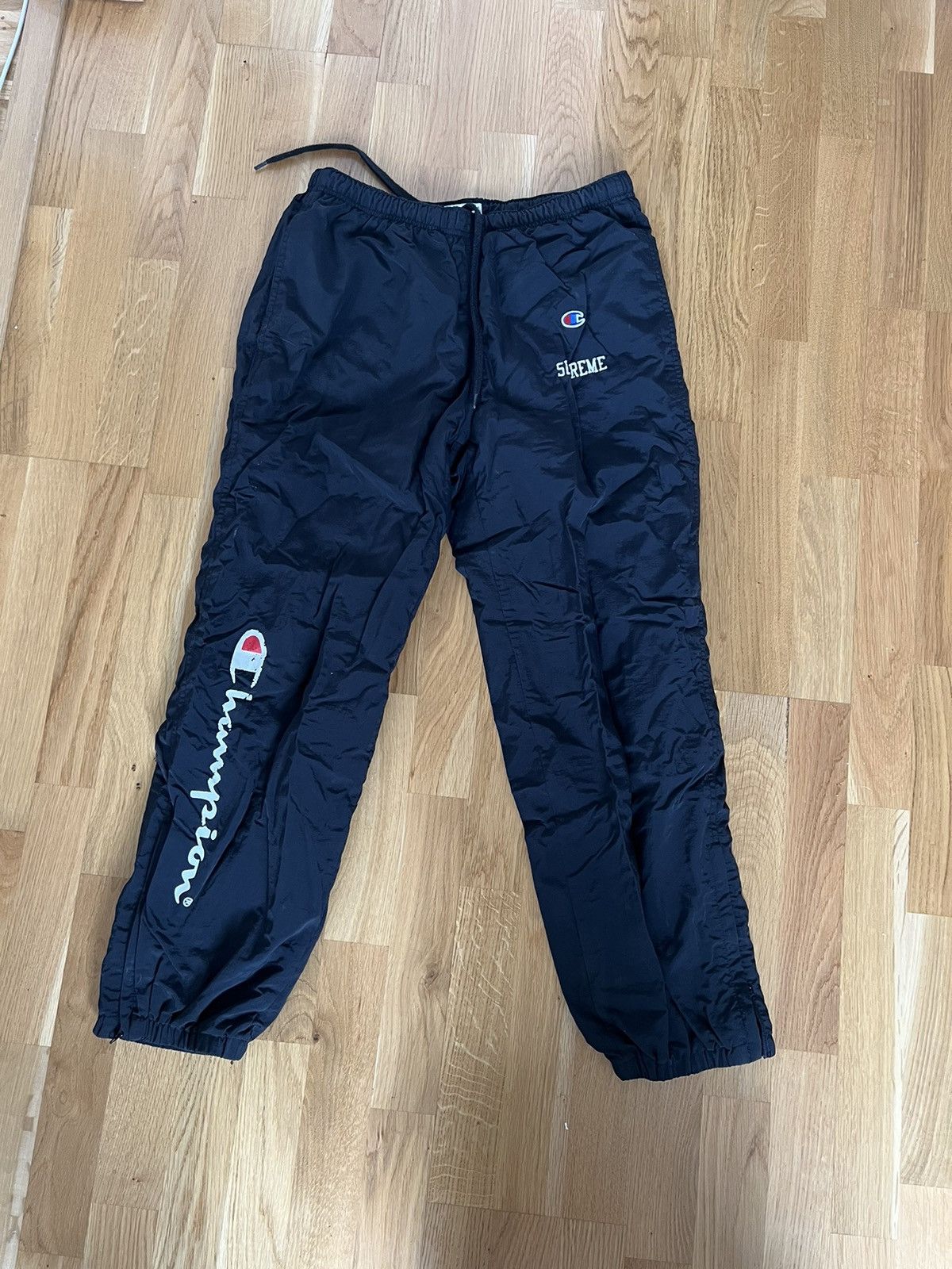 Champion supreme track pants best sale