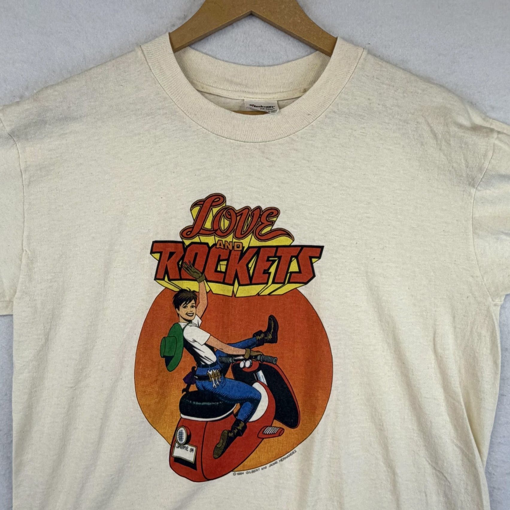 Vintage VINTAGE Love and Rockets Graphitti Tee Mens L Ivory 80s Comics Motorcycle Crew Neck Cotton T-Shirt Short Sleeve Graphic Print Stedman Made in USA Mens Size US L / EU 52-54 / 3 - 6 Thumbnail