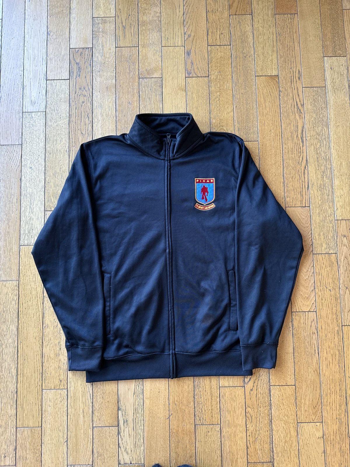 image of Champion x Disney Employee Jacket Disney Pixar Studios Usa Staff Buzz in Black, Men's (Size Large)