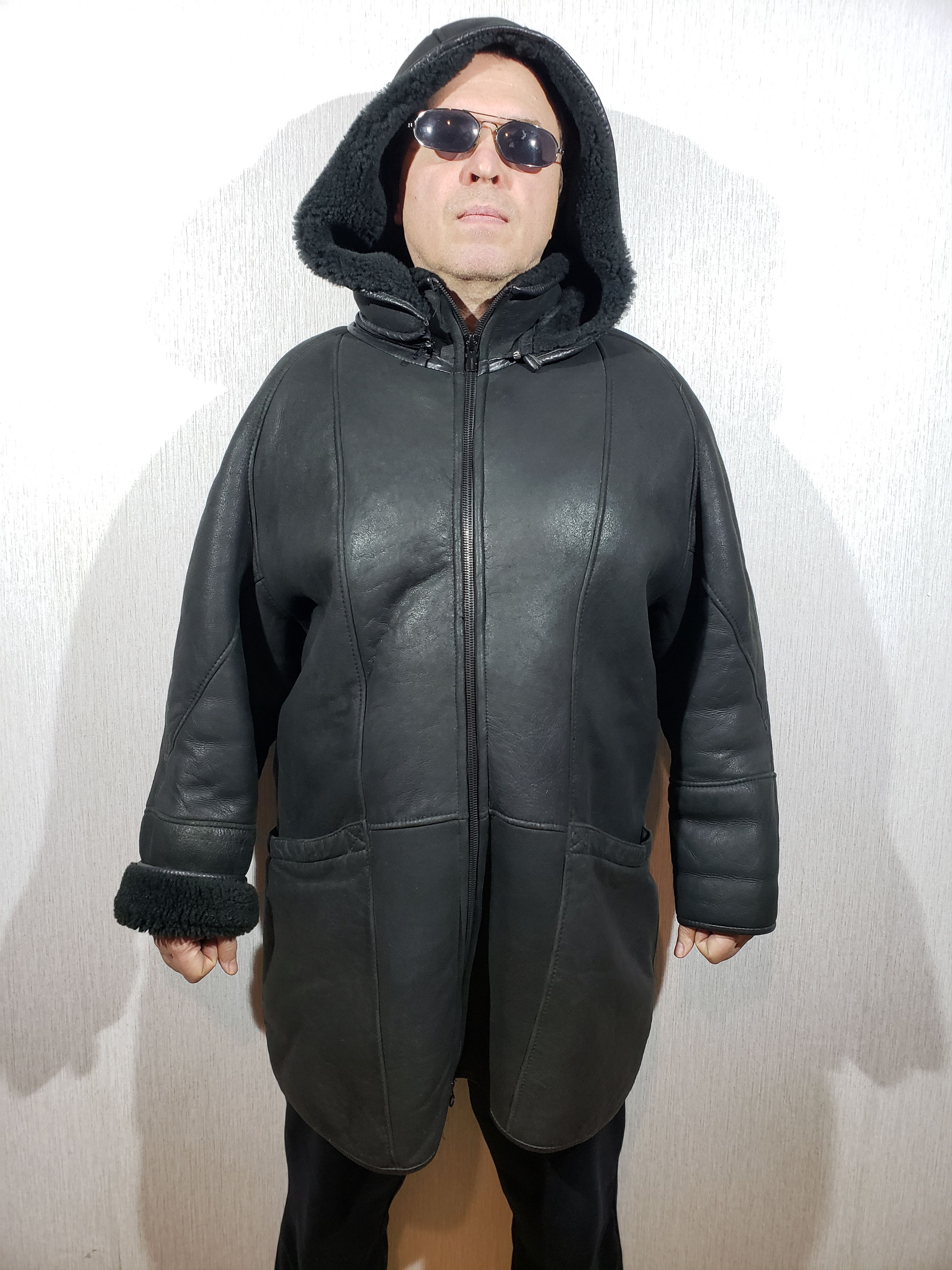 Wonderful men's black sheepskin coat with a hood.