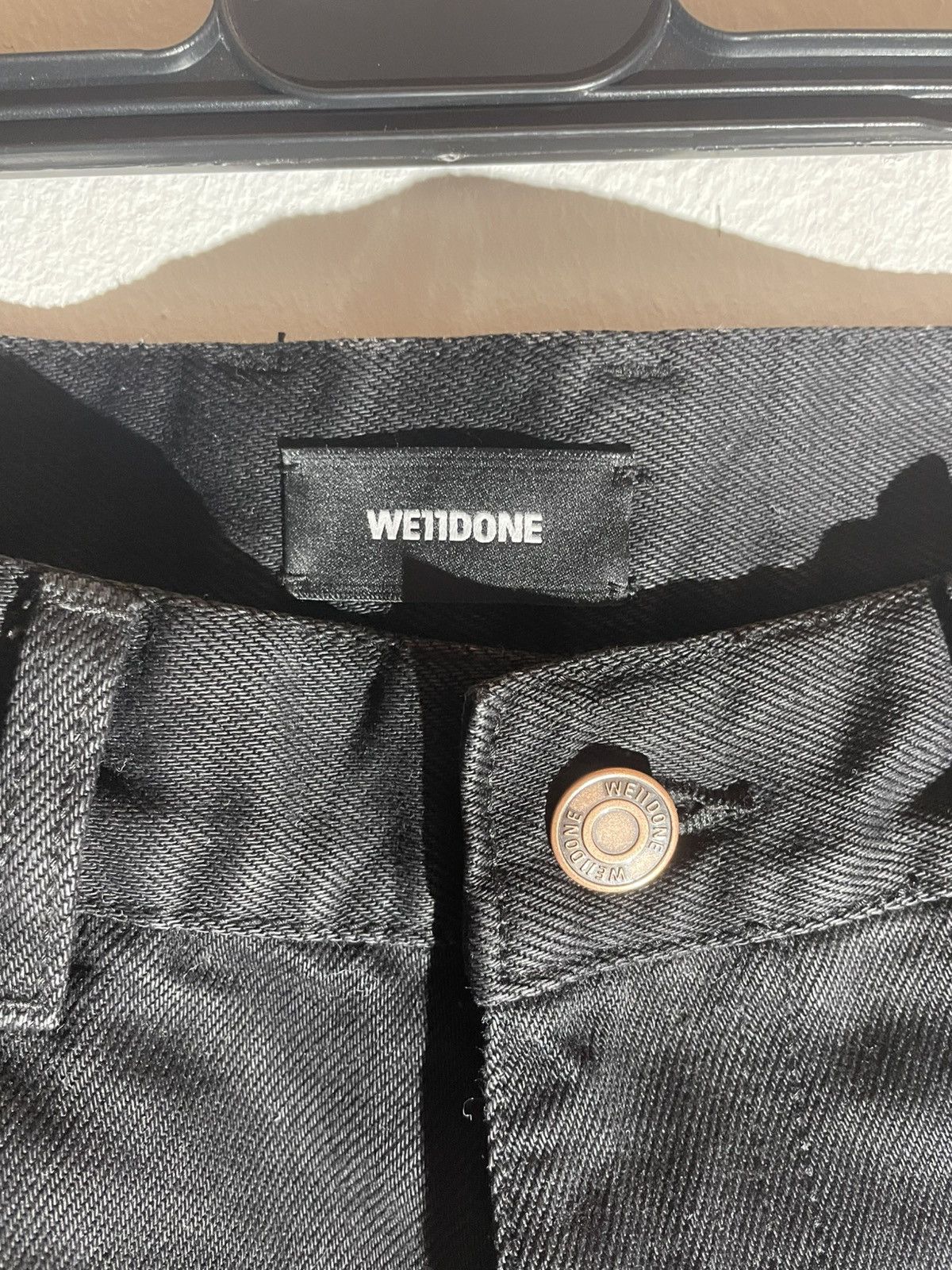 WE11DONE black distressed jeans