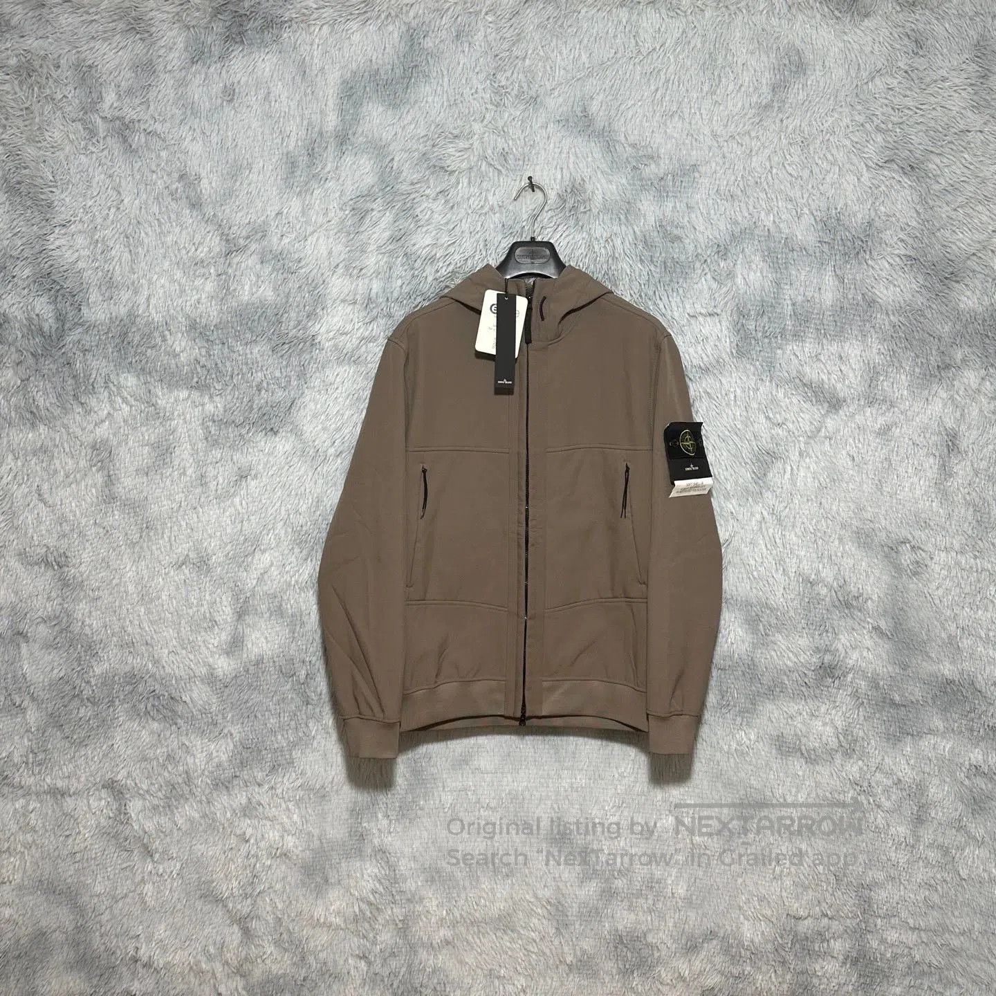 brown hooded softshell jacket by stone island.