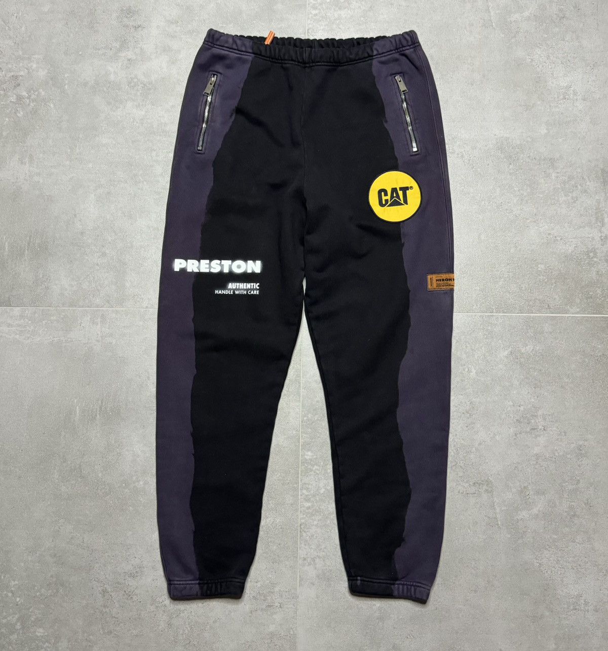 image of Caterpillar x Heron Preston "heron Preston X Cat Workers Painted Faded Sweatpants " in Navy/Purple 