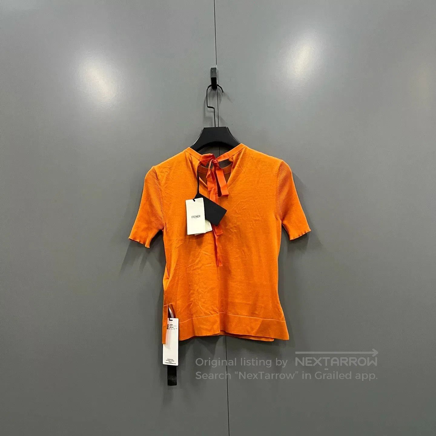 orange embroidered short sleeve sweater.