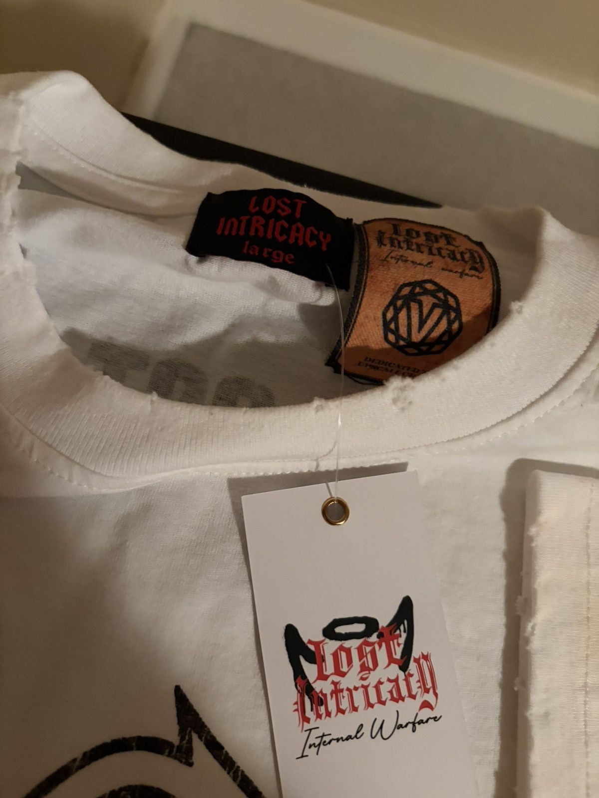 LOST INTRICACY LOST INTRICACY white “LOST” tee SZ Large Size US L / EU 52-54 / 3 - 4 Thumbnail